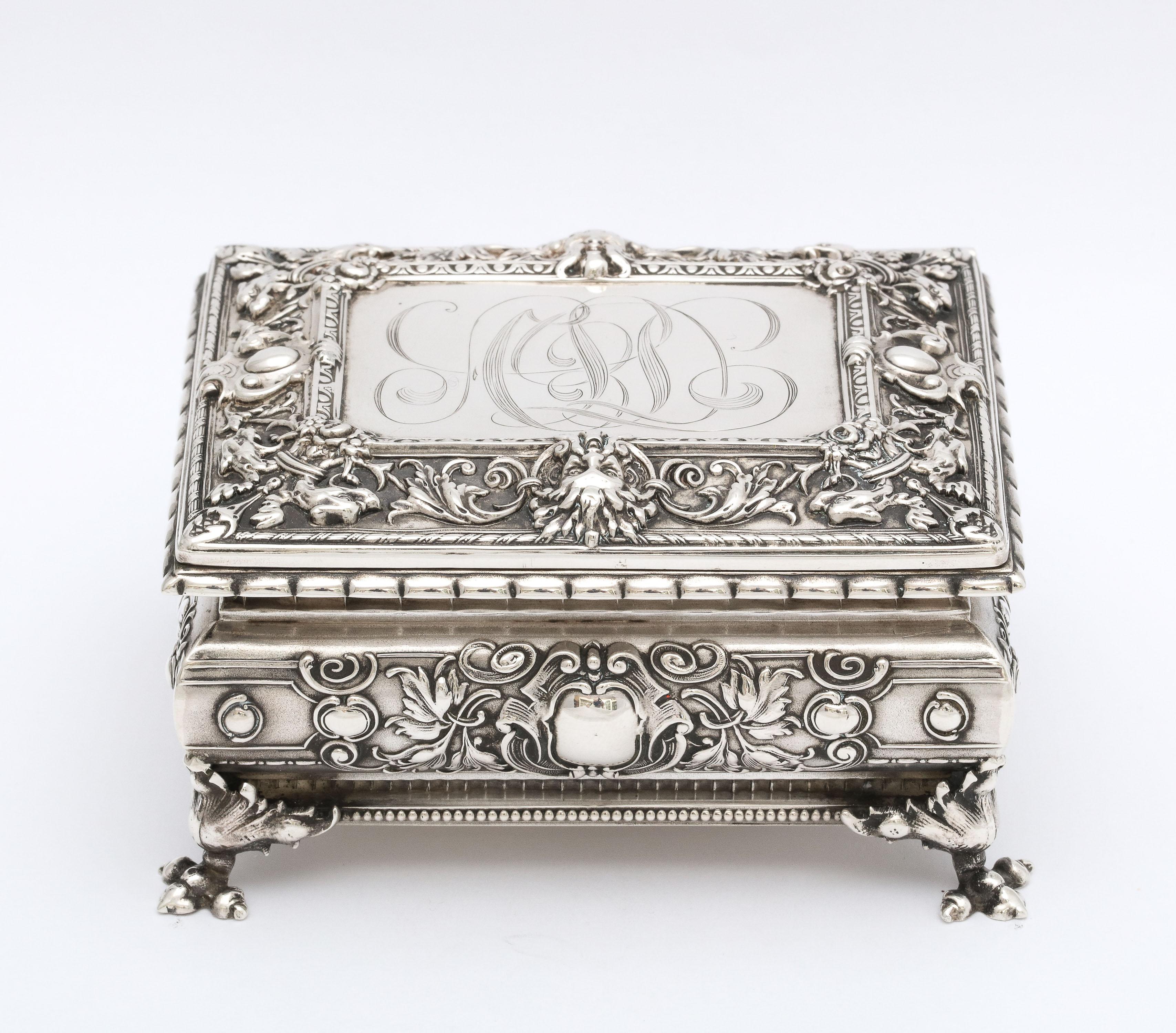 Victorian period, sterling silver, footed jewelry/trinkets box with hinged lid, William B. Kerr and Company, New Jersey, Ca. 1895 - makers. Decorated with intertwining leaves and vines. Top of lid has a Green Man motif (symbolizes good luck). Box