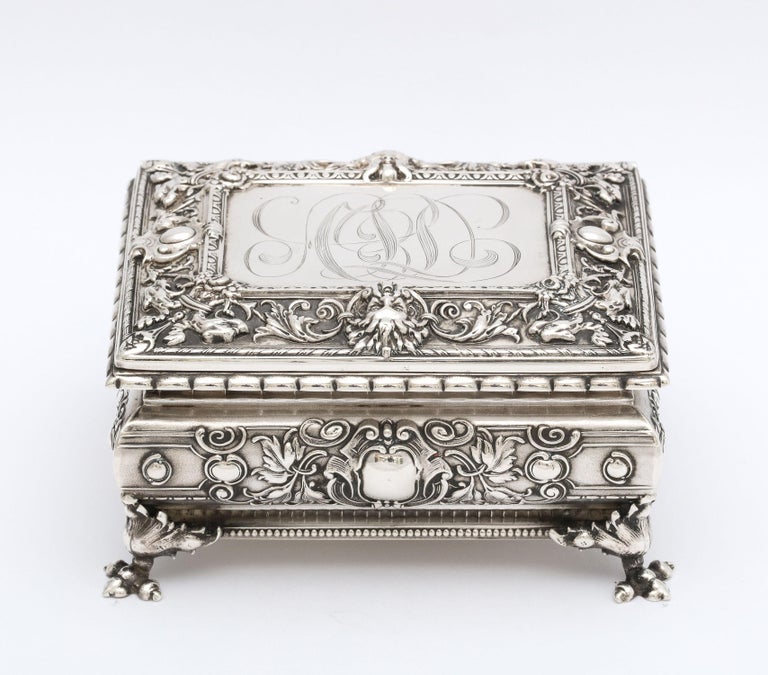 Victorian period, sterling silver, footed jewelry/trinkets box with hinged lid, William B. Kerr and Company, New Jersey, Ca. 1895 - makers. Decorated with intertwining leaves and vines. Top of lid has a Green Man motif (symbolizes good luck). Box