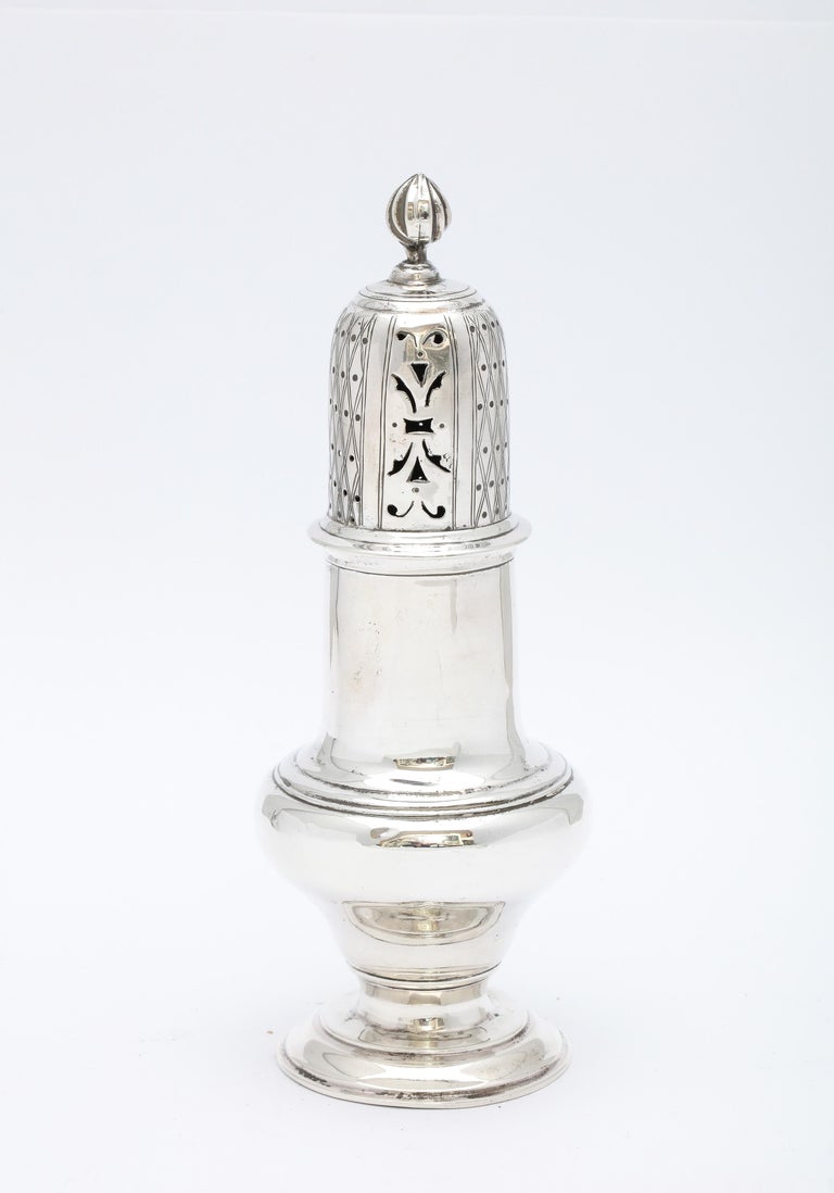 Victorian Period, sterling silver muffineer/sugar caster, Birmingham, England,, year-hallmarked for 1899. Measures 7 inches high (at highest point - top of finial) x 2 3/4 inches diameter (at widest point). Weighs 3.140 Troy ounces. Dark areas on