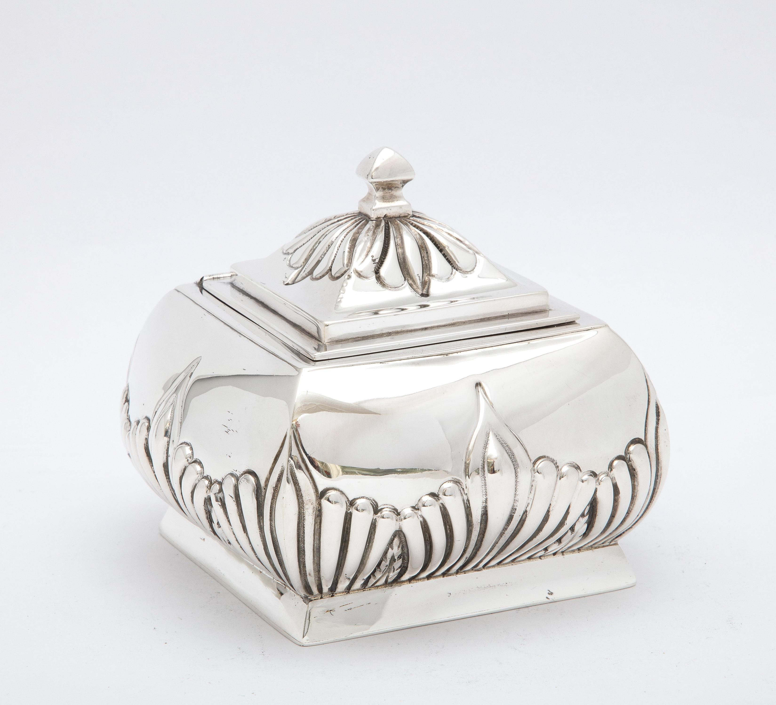 Victorian Period, sterling silver tea caddy with hinged lid, Birmingham, England, year-hallmarked for 1891, Stokes and Ireland, Ltd. - makers. Lovely design, having a square pedestal base and rounded corners. Measures 4 1/2 inches high (to top of
