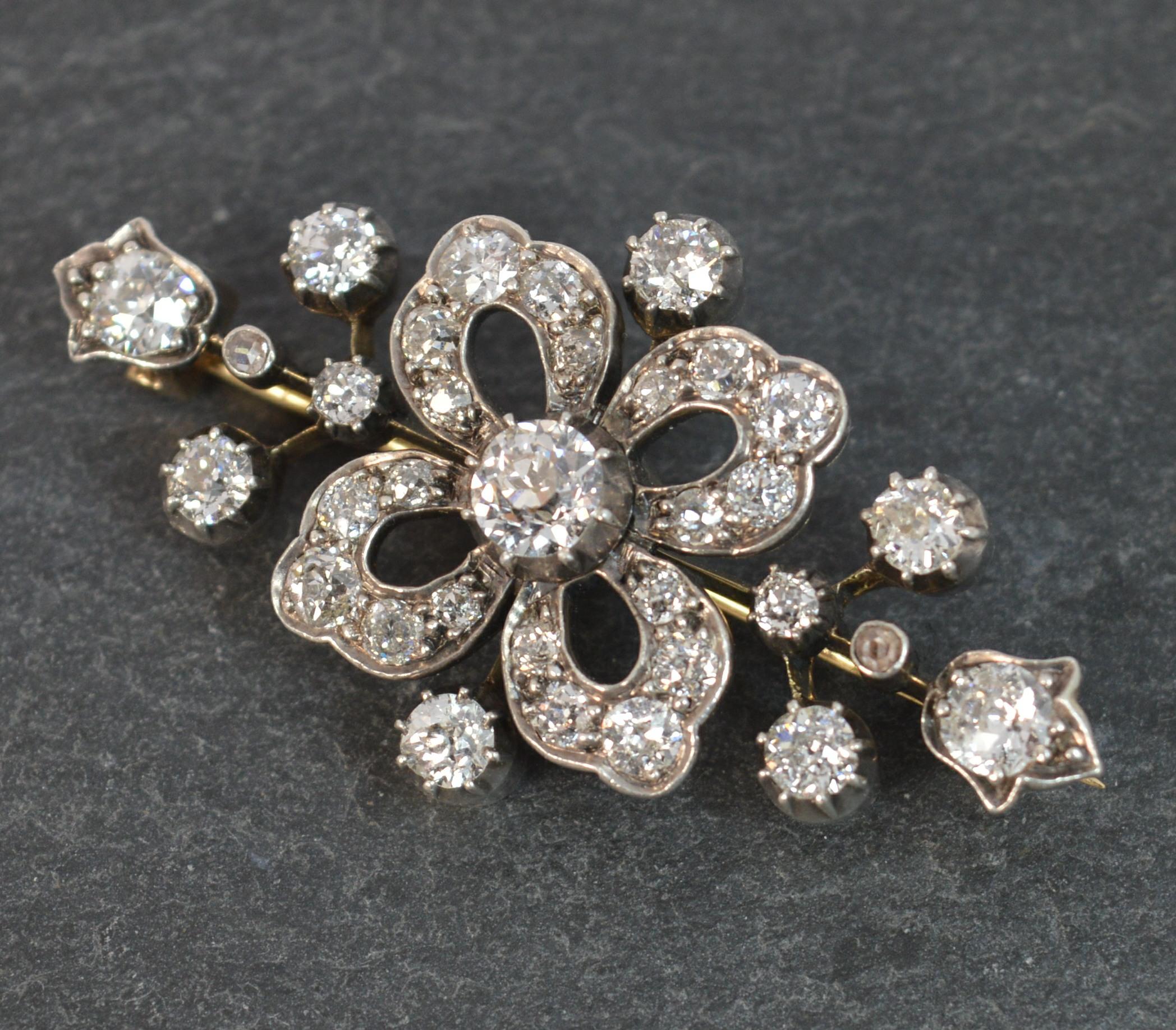
An exceedingly good Victorian period brooch.

Modelled in 18ct rose gold with a silver head setting, typical of the period.

Set with many old cut diamonds, each of VS clarity, g-h colour and a total carat weight of approx 2.5 carats. Central