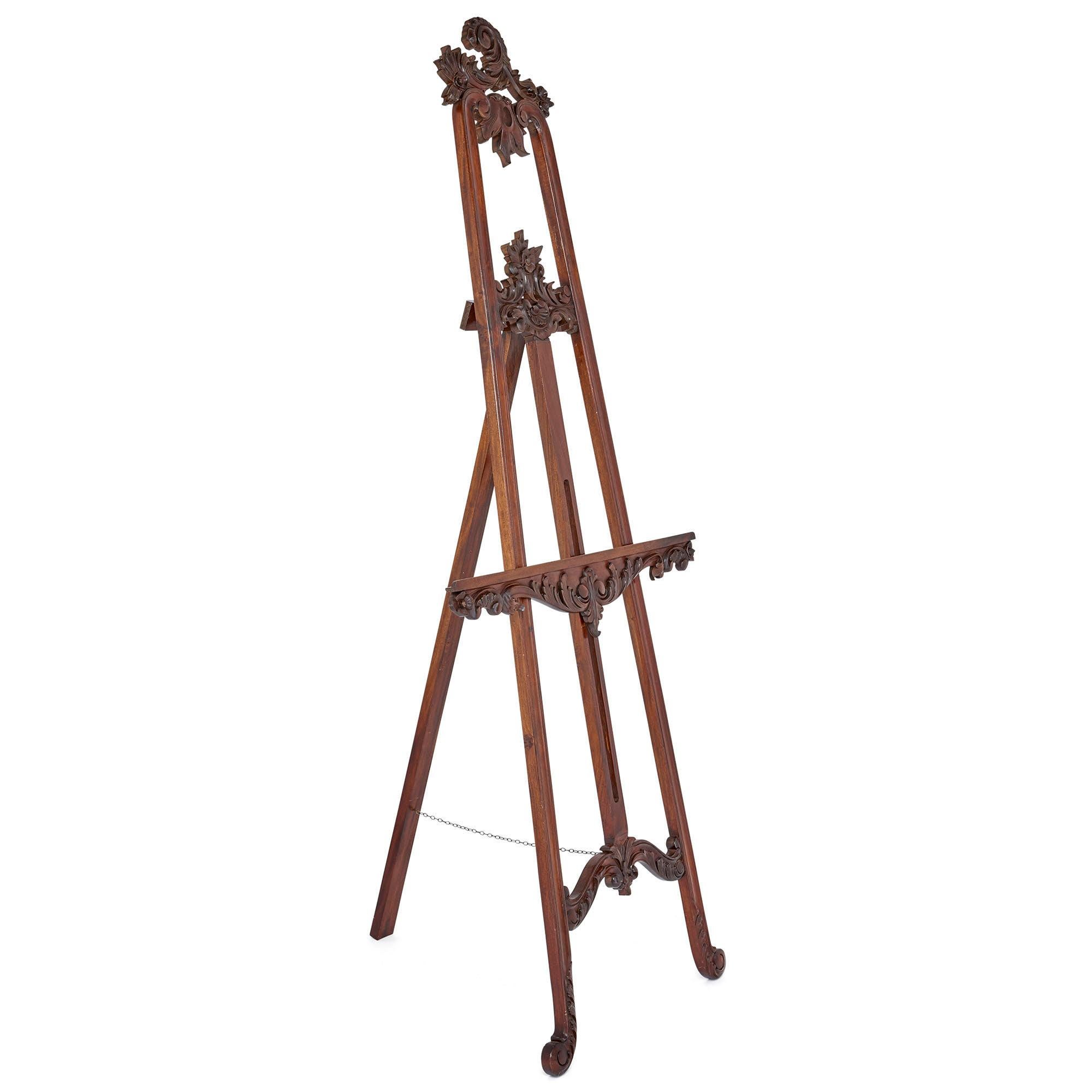 This beautiful artist’s easel was created in England in circa 1900, in the early 20th century. The easel is of tripod form, being set on three supports. Its feet and top are scrolled. The easel features a horizontal member, upon which the artist’s