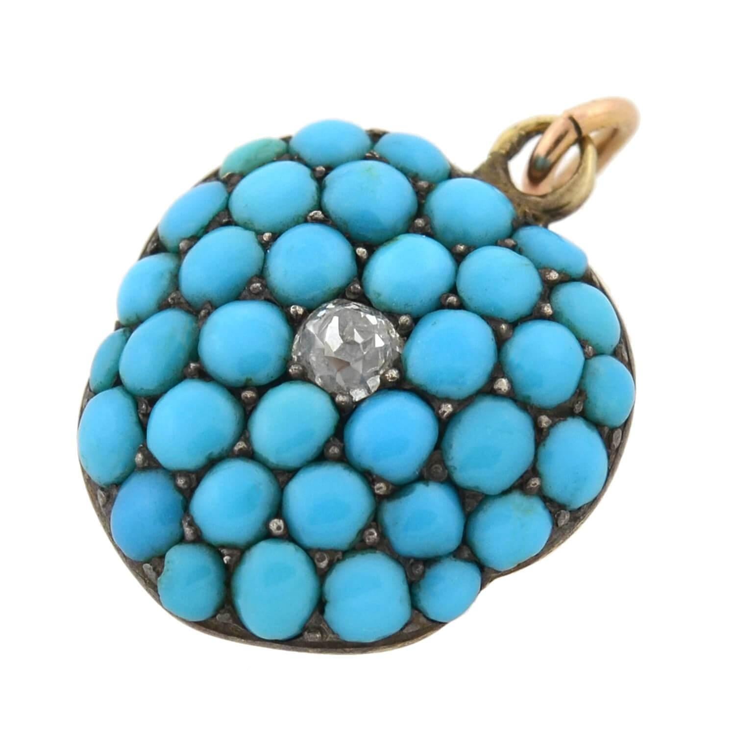 A gorgeous turquoise locket from the Victorian (ca1880) era! This lovely piece is crafted in 15kt yellow gold and sterling silver and forms a shape closely resembling a puffy heart or flower. Completely covering the front surface is a vibrant array
