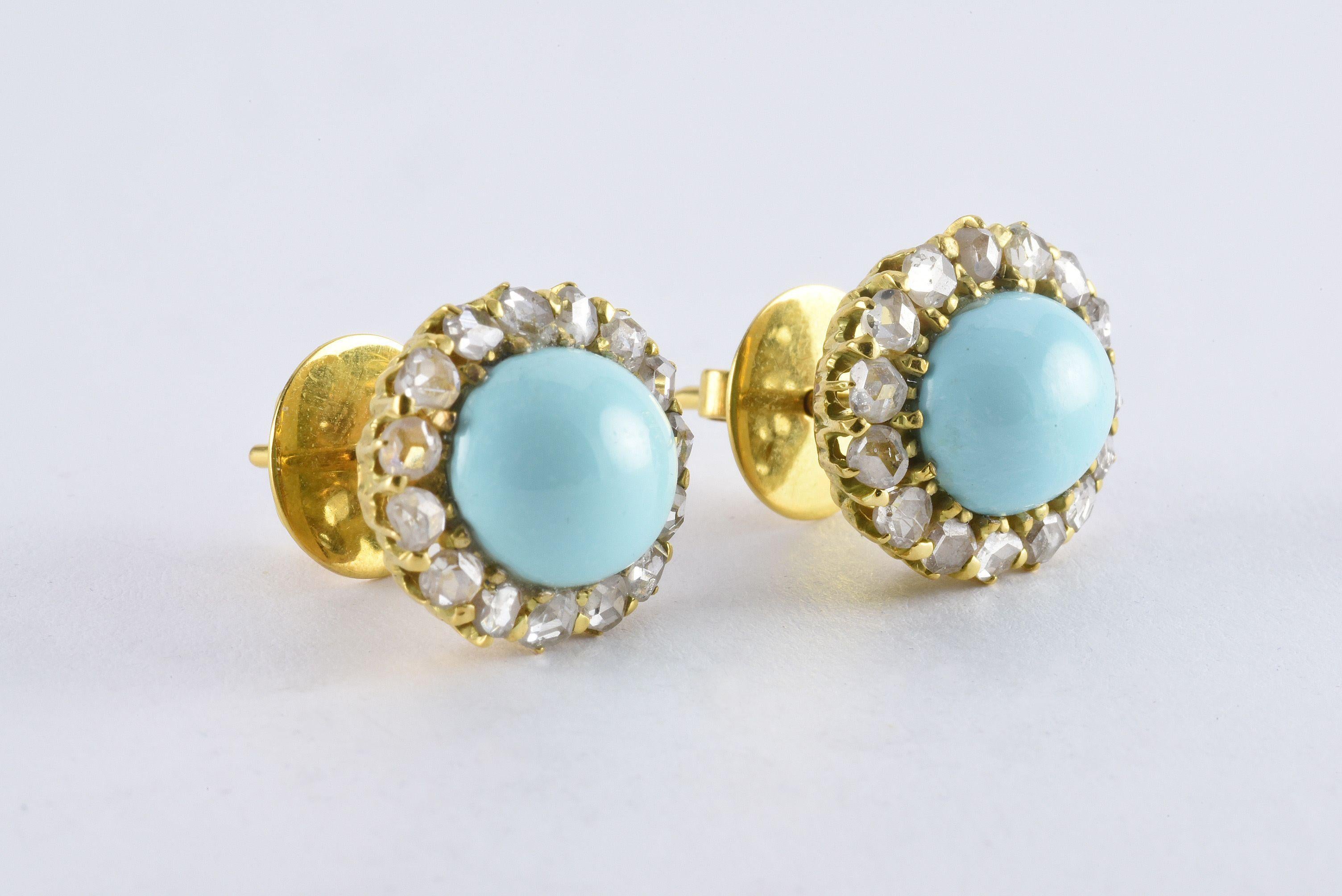 These beautiful Victorian 18kt yellow gold earrings feature two natural oval-shaped Persian turquoise cabochons measuring 10 mm x 11.5 mm surrounded by thirty rose-cut diamonds totaling approximately 1.00 carat. The earrings measure 17.20 mm x 15.5