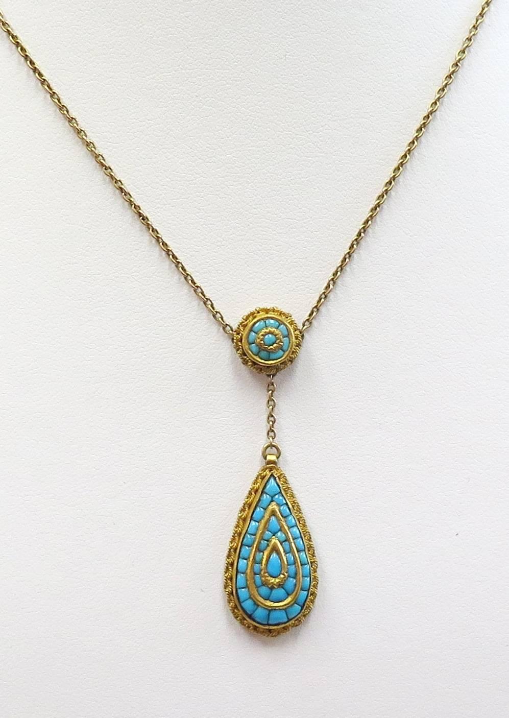 Stunning antique pendant with genuine Persian turquoise stones in a secure tested 14 karat yellow gold setting. Based on my research I believe this item is from the late 1800s Victorian era. This pendant is in wonderful condition. 

Length of