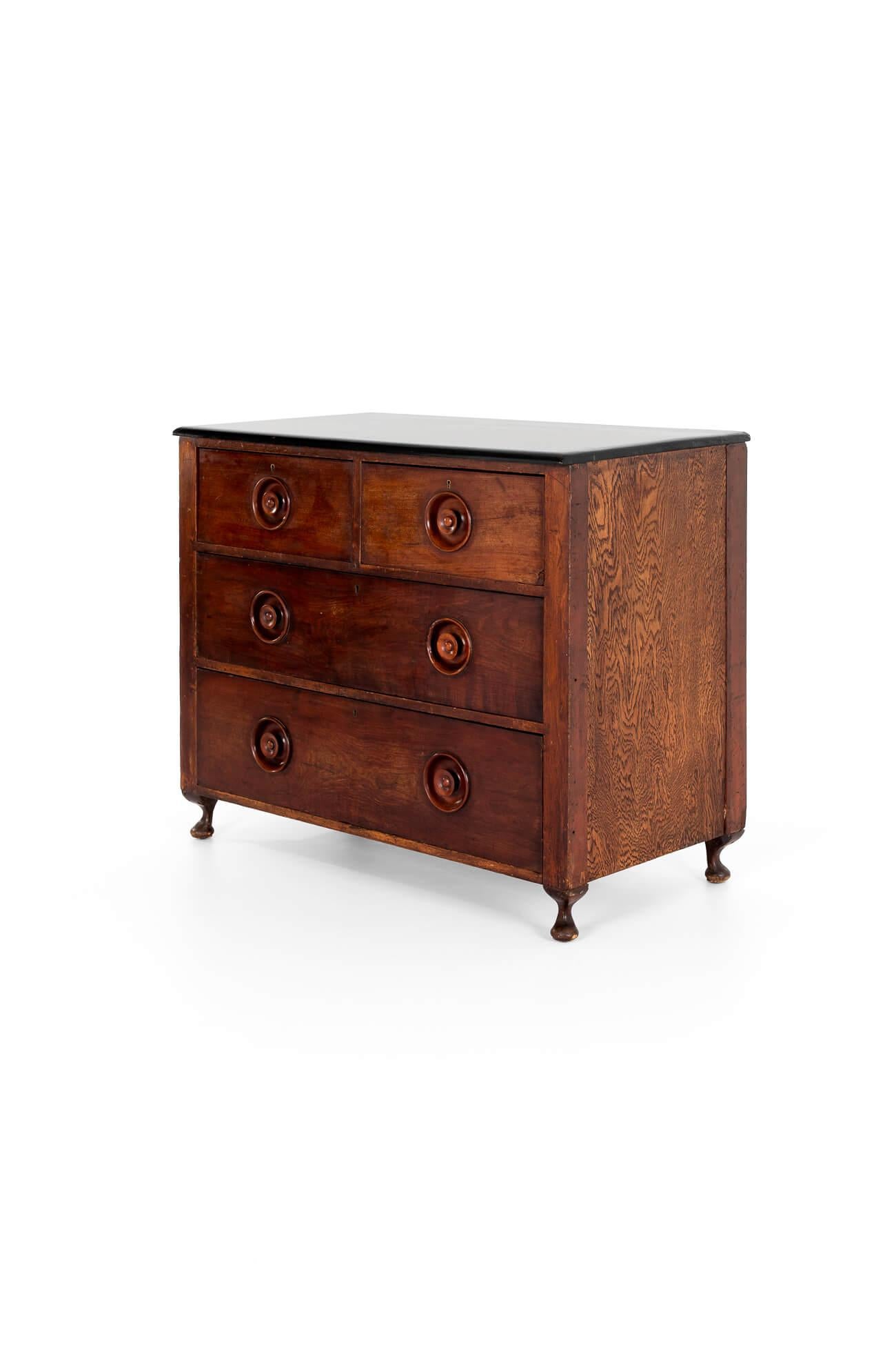 A Victorian pharmacy chest in pine, with mahogany fronted drawers.

The chest has a thick ebonised top, leading to two short over two long graduating drawers, raised on cabriole legs.

Each draw has turned recessed handles with brass