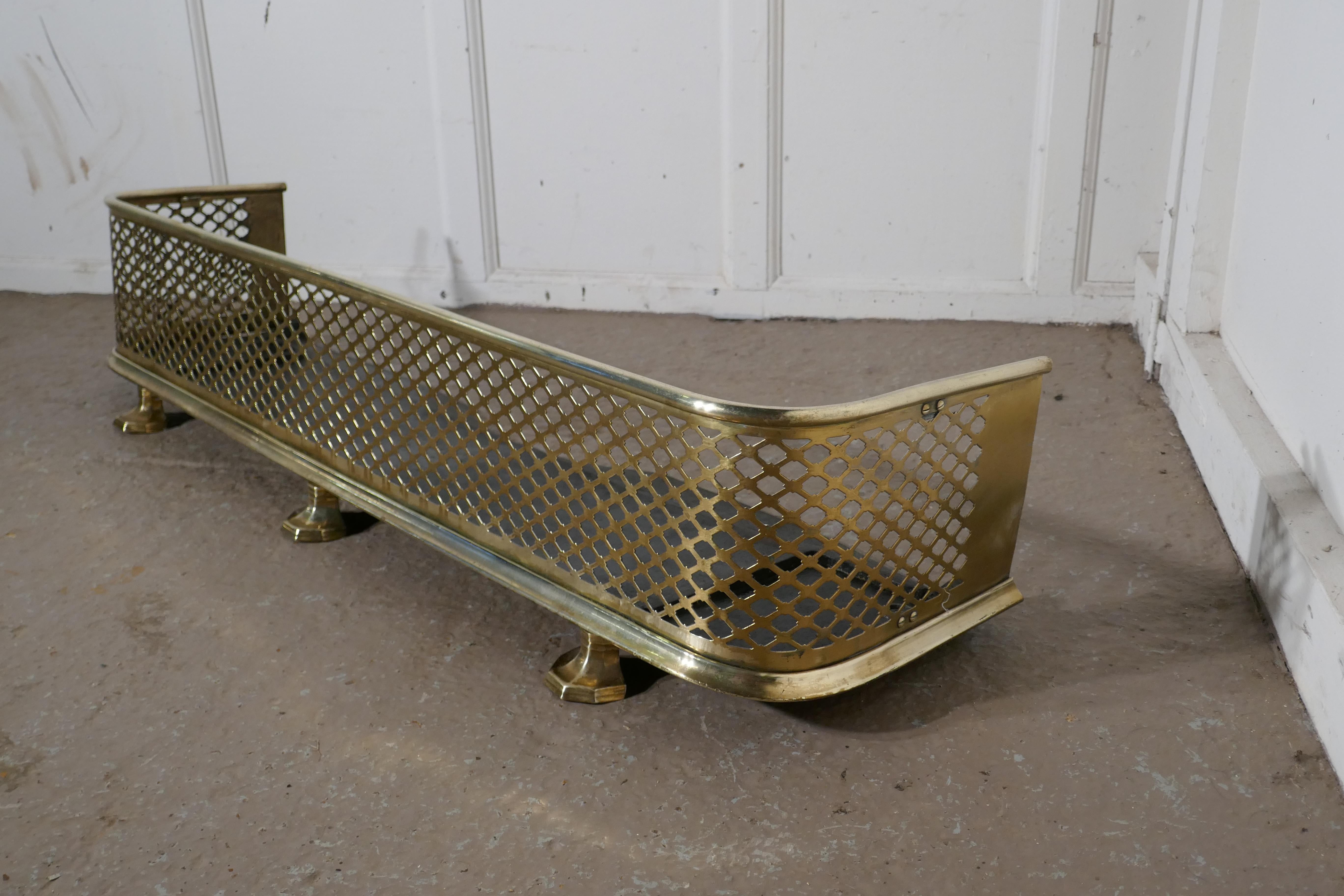 Victorian pierced brass fender 

This is a Victorian pierced brass fender, it stand on small feet at the front which tilts the fender so that any spilt ash etc. Will roll back into the fire
The Fender is in very good condition it is 10” high, 14”