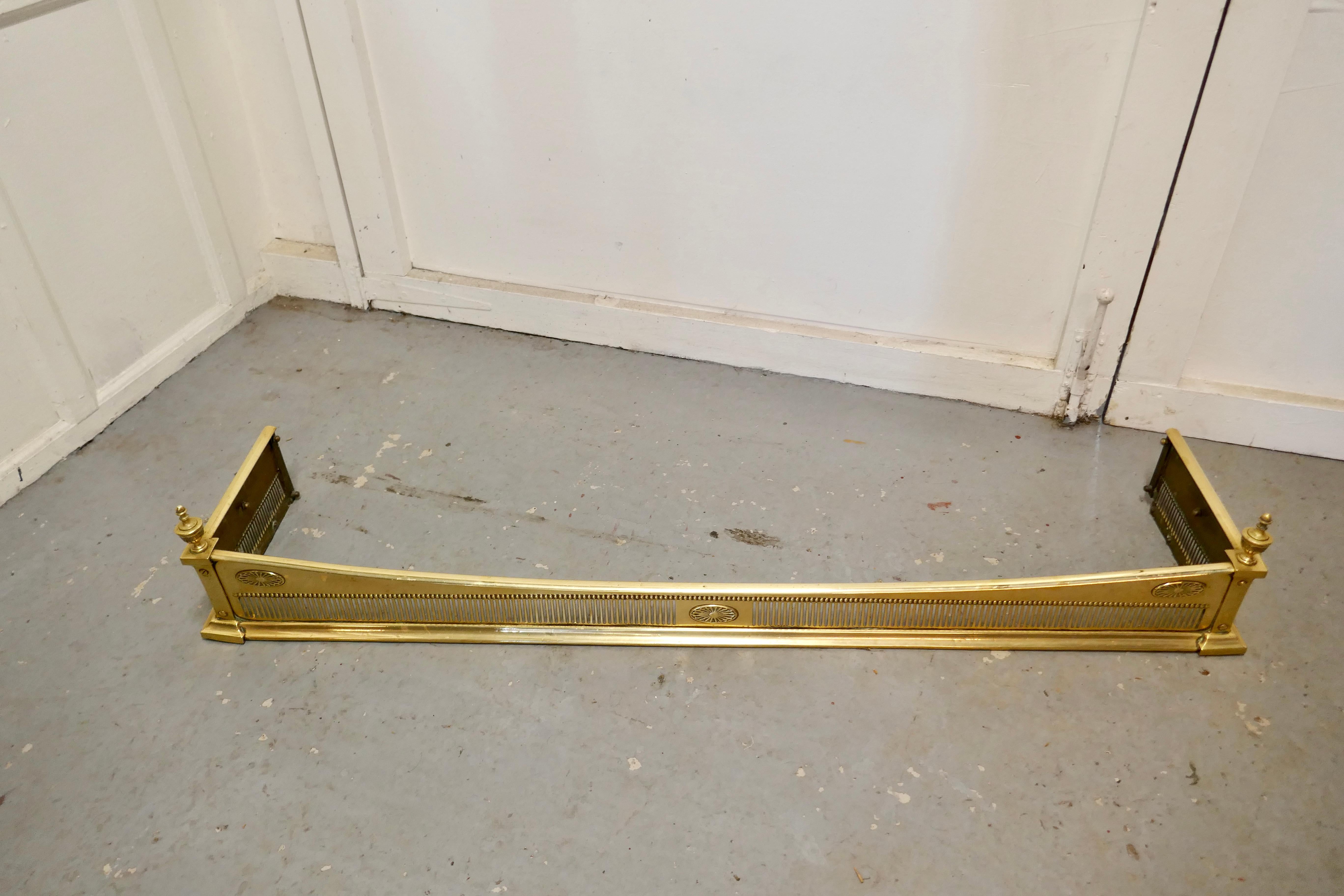 Victorian pierced brass fender

This is a very superior quality Victorian pierced brass fender it has an upward sweeping top rail with piercing along the front and turned finials at either end 
The fender is in Very good Condition it is 9” high,