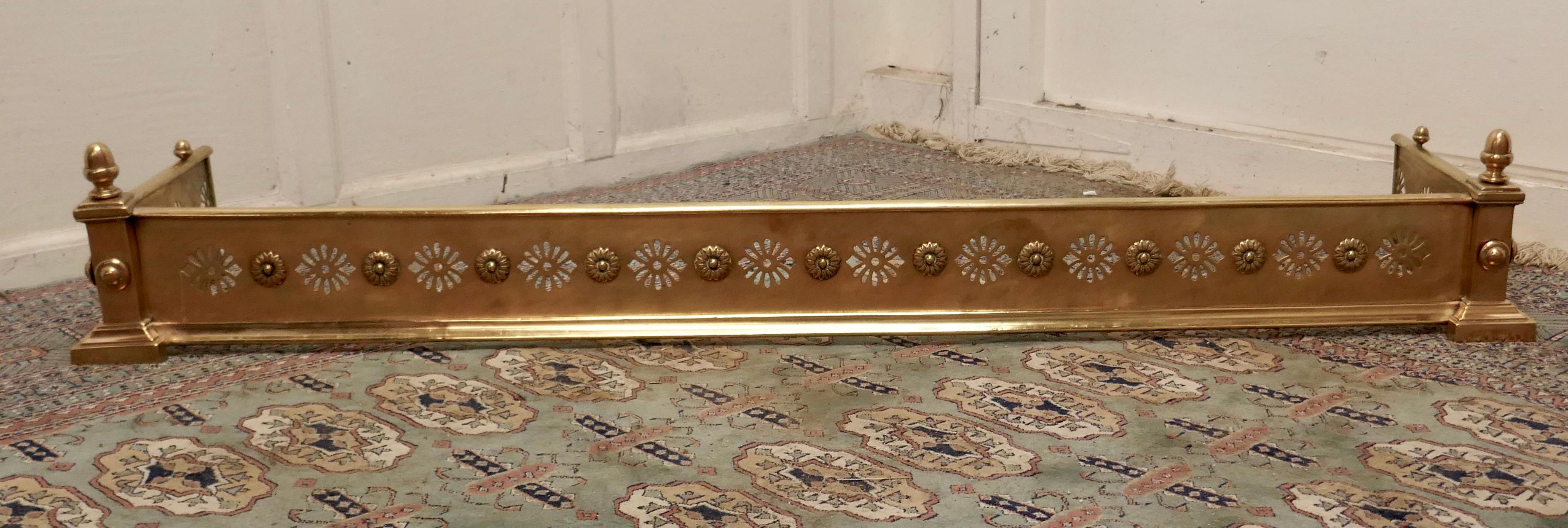 Victorian pierced brass fender

This is a very superior quality Victorian pierced brass fender it has circular piercing and roundels along the front and sides with turned finials at each end 
The fender is in very good condition it is 9” high,