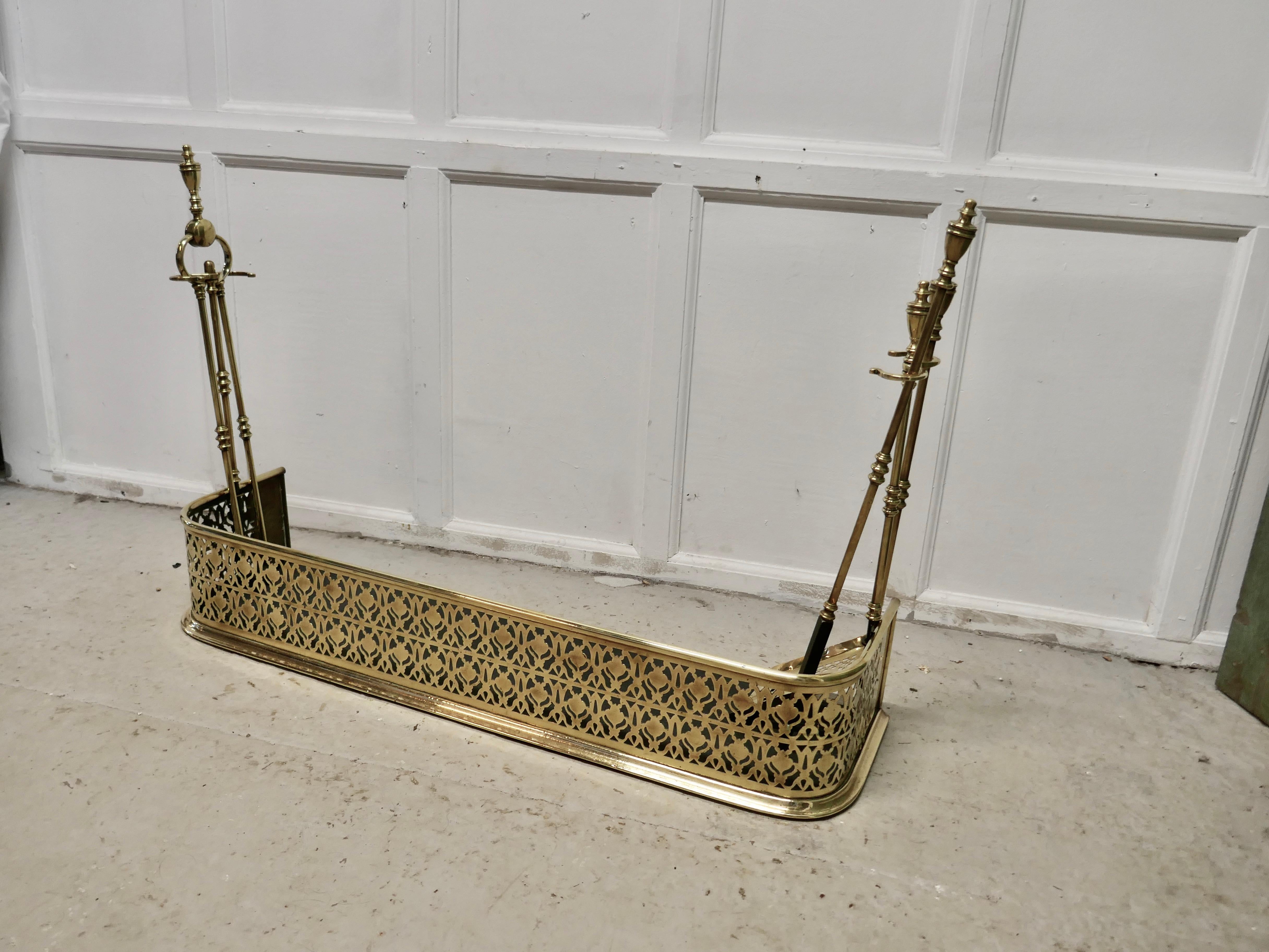 Victorian pierced brass fender with fire irons

This is a Victorian pierced brass fender, on either side it has a support to keep the fire irons or Companion set in place. The 3 Irons are original to the fender, you can see the turnings on the top