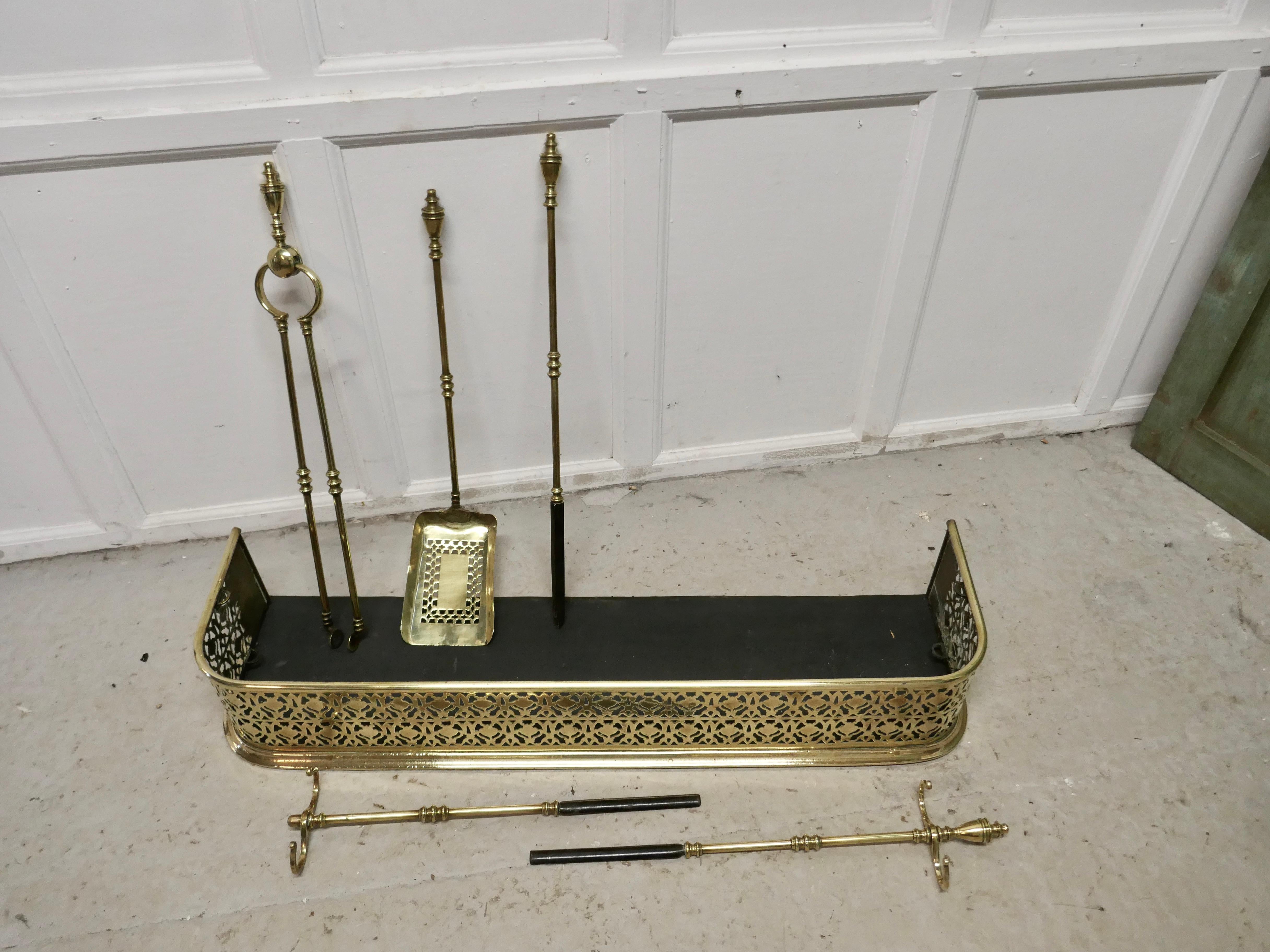 19th Century Victorian Pierced Brass Fender with Fire Irons For Sale