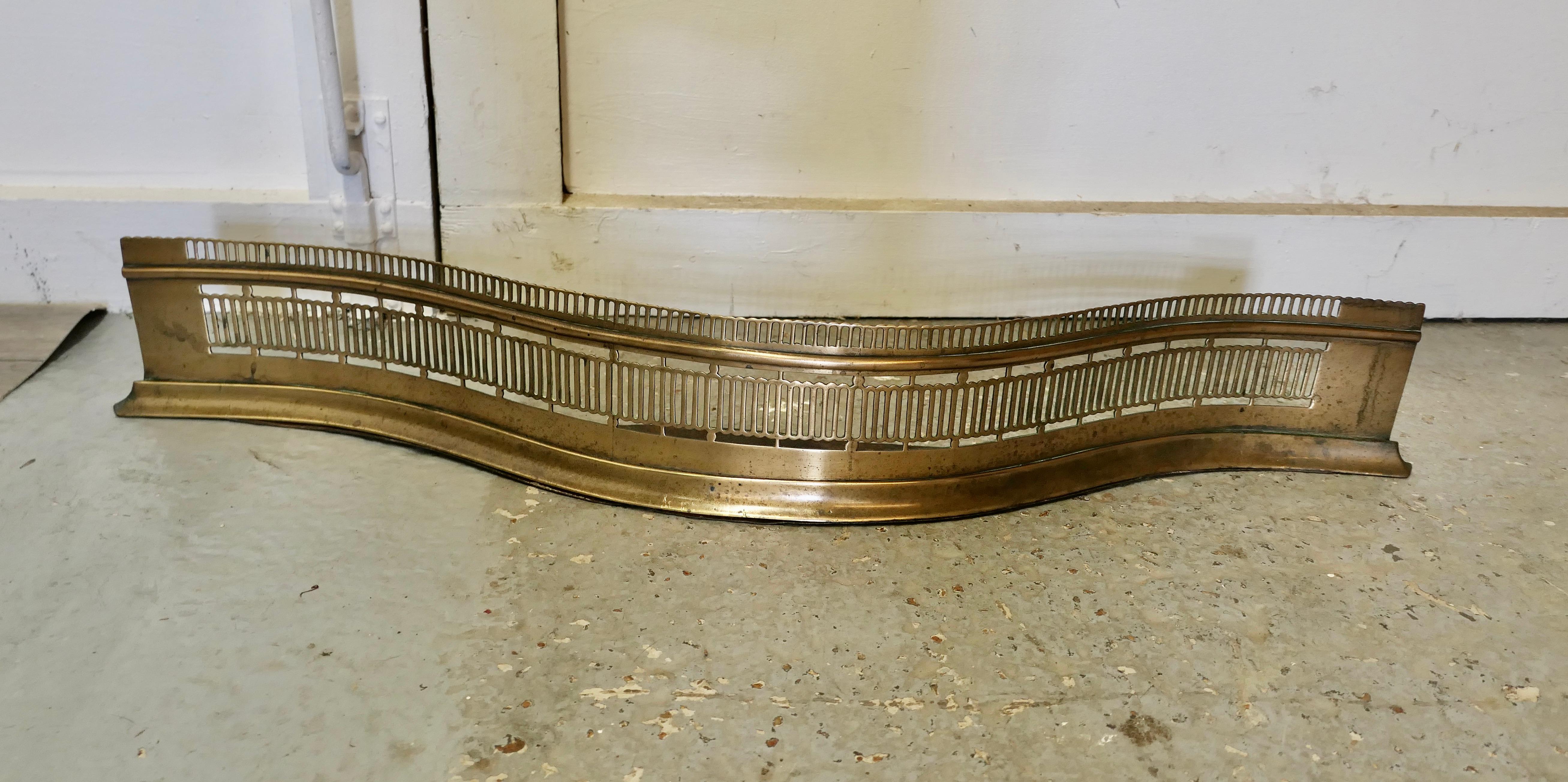 Victorian Pierced Serpentine Shaped Brass Fender 

This is a Victorian antique fender unusually this one has a serpentine shape, the fender has an attractive pierced brass front 
The fender is in very good all round condition and would grace any