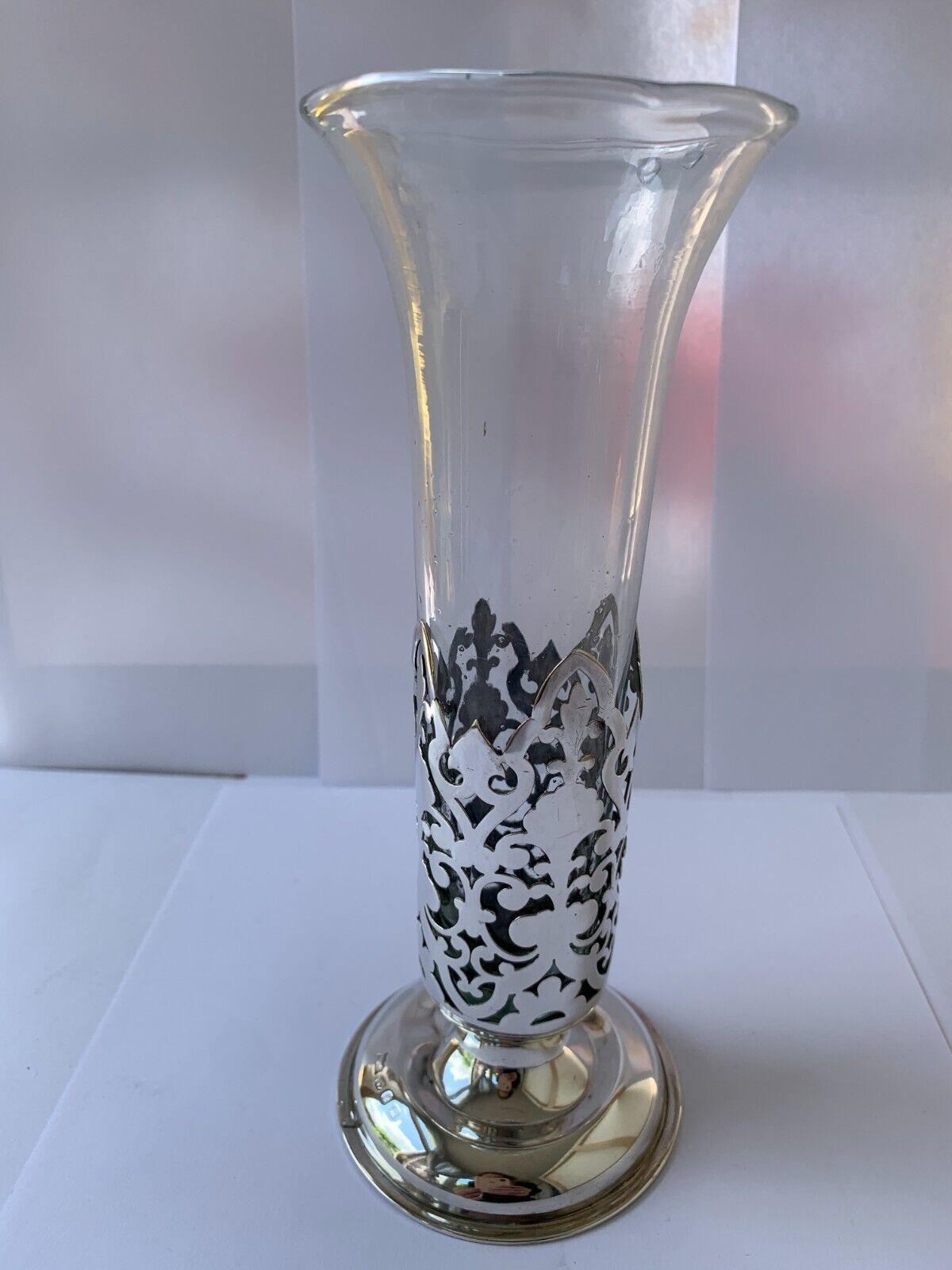 This is a beautiful pierced sterling silver vase with a round pedestal base is in good vintage condition. It has a lovely design, sadly a small bit of the silver is missing, this is reflected in the price.
The clear glass is original and in