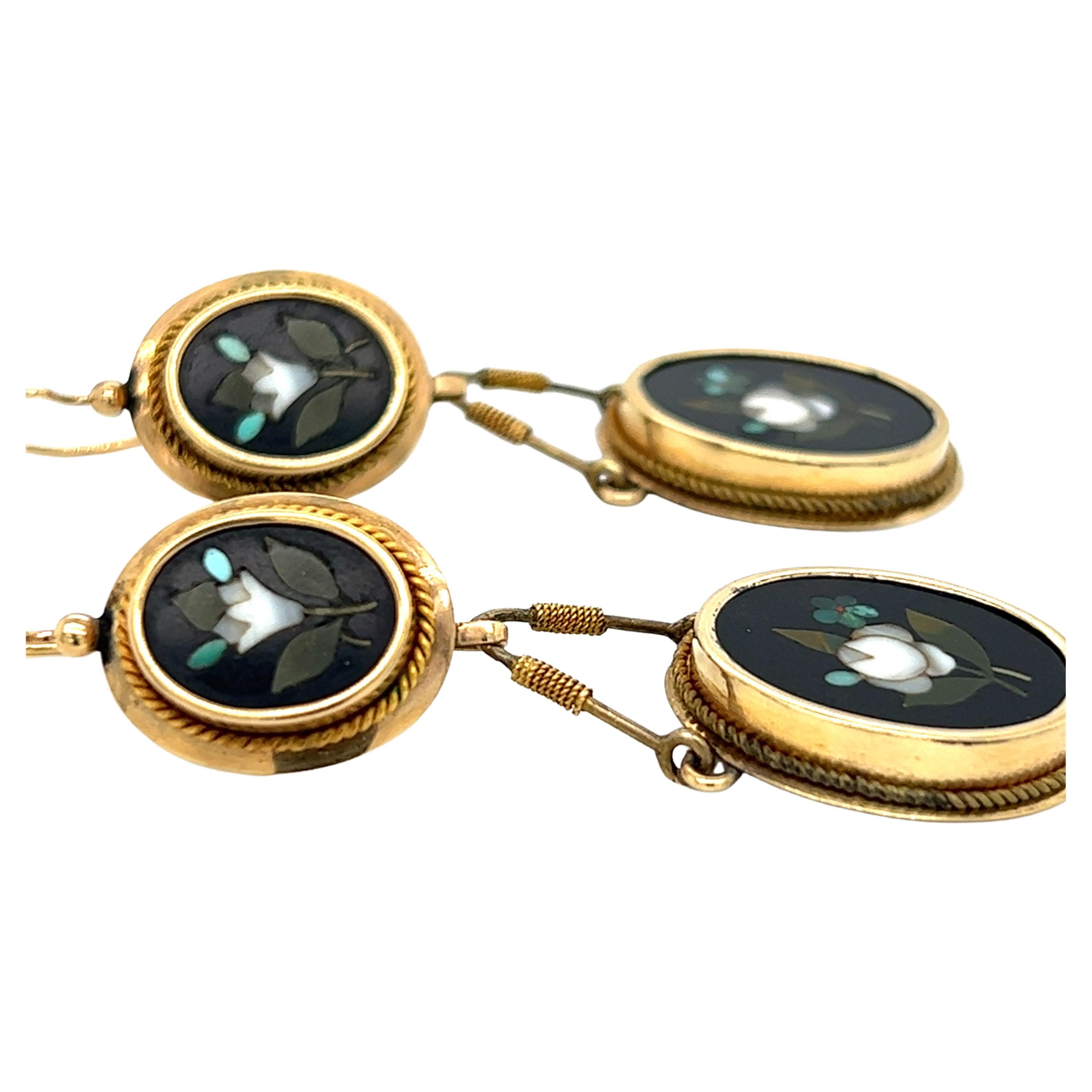 One pair of 14-karat yellow gold Victorian Pietra Dura mosaic twin oval drop pendant design earrings.  The earrings measure approximately 2.25 inches long and are complete with traditional hook closures.