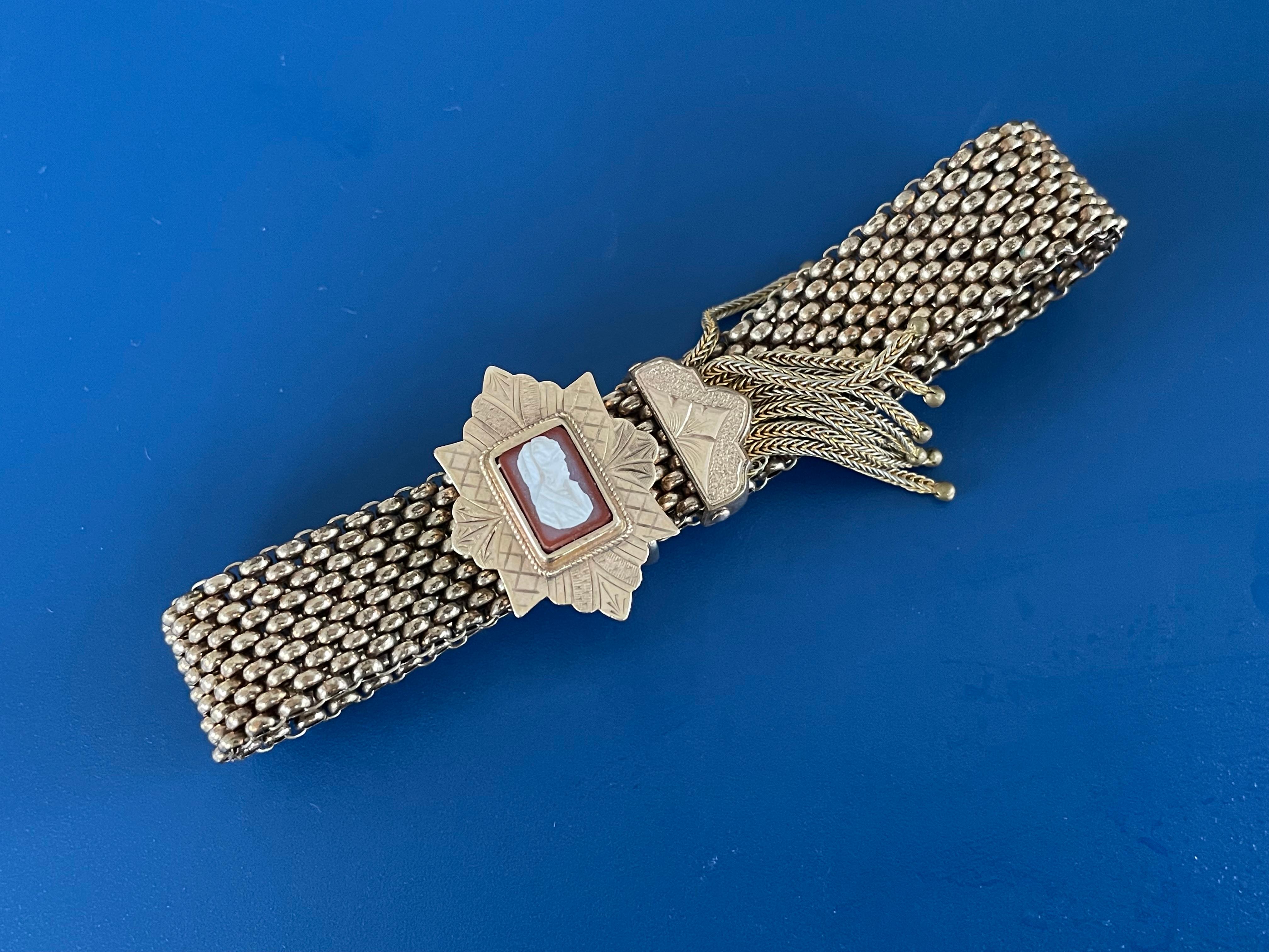 This bracelet incorporates two features which are appreciated by vintage jewelry fans:  the slide; and the tassel.

The cameo slides perfectly on the flexible, mesh bracelet.

Bracelet dimensions: approximately 1/2