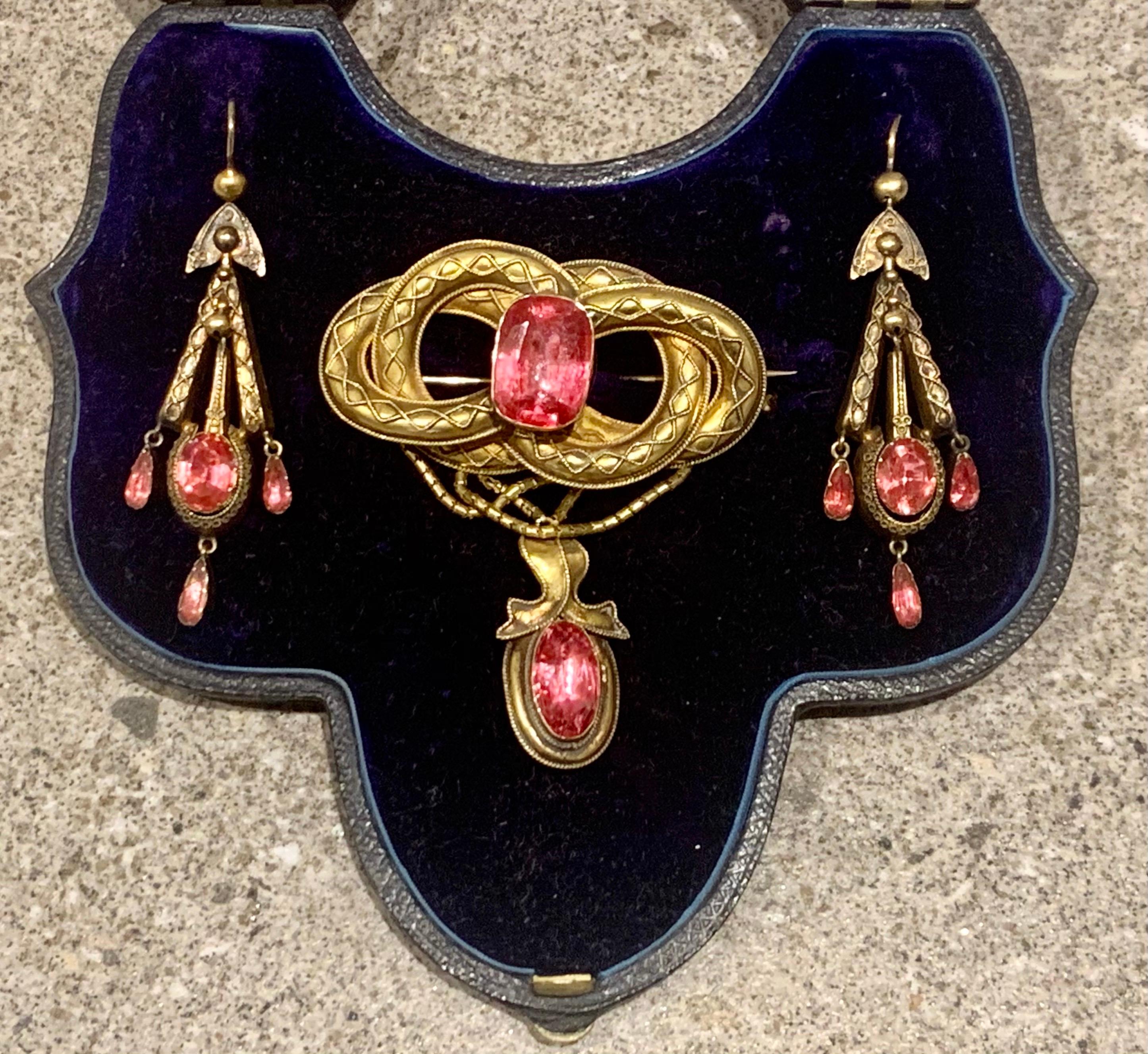 A antique Victorian pink tourmaline set pinchbeck locket back Brooch and Earring Set In superb antique condition. In the original antique velvet lined dome top presentation box. The brooch is (6 cm) Tal by (5.2 cm) wide,
In very nice antique