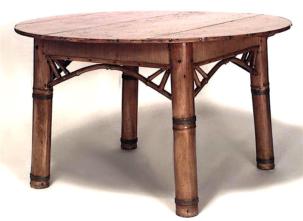 Bamboo English Victorian large 4 legged round dining table with pine top and recessed woven apron.
