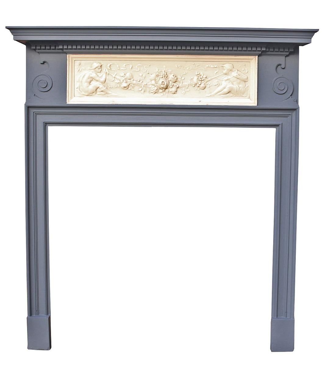 A striking surround, painted in grey, with cream centre tablet.

Measures: Opening height 102 cm

Opening width 101 cm

Width between outside of legs 122 cm.