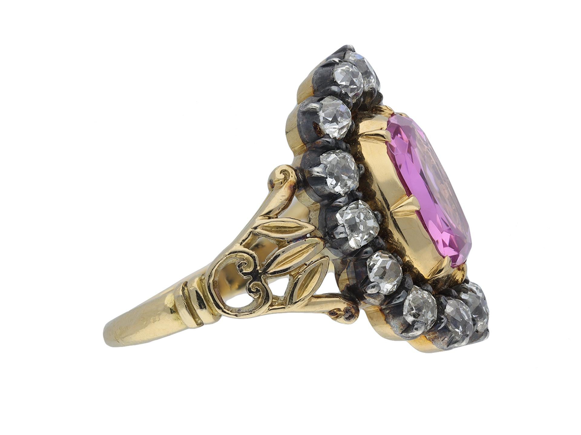 Victorian pink topaz and diamond cluster ring. Centrally set with a cushion shape old cut natural unenhanced pink topaz in an open back cut down setting with an approximate weight of 3.45 carats, encircled by a single row of sixteen cushion shape