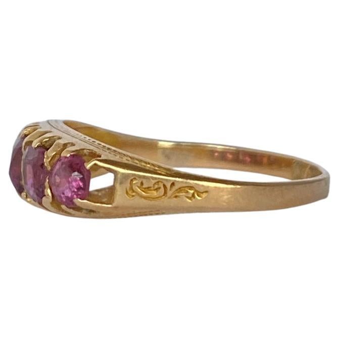 This stunner holds five deep pink tourmaline that are beautifully cut and catch the light just right to get that sparkle. They are set almost flush within the 15ct gold band. 

Ring Size: L or 5 3/4 
Band Width: 5mm

Weight: 1.85g