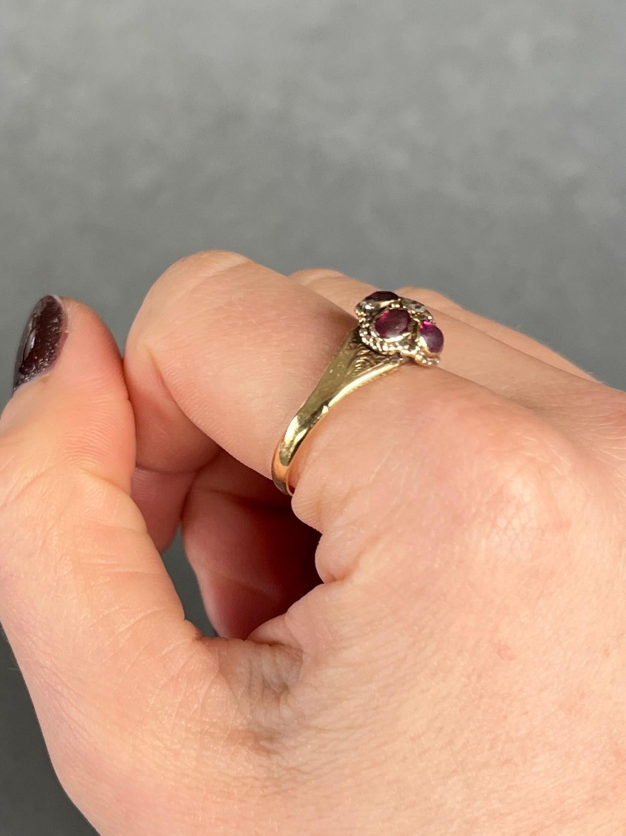 This stunner holds four deep pink tourmaline stones totalling 80pts and at the centre sits a 5pt rose cut diamond. They are set almost flush within the 15ct gold band. 

Ring Size: S or 9    
Head Width: 10mm

Weight: 2.9g