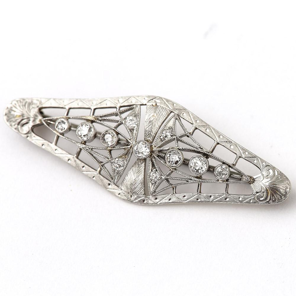 A finely crafted Art Noveau period platinum diamond brooch, duly inspired by nature displaying butterfly wings or perhaps a spider’s web as influence. The brooch has a textured surface which was entirely tooled by hand. Having eleven old cut