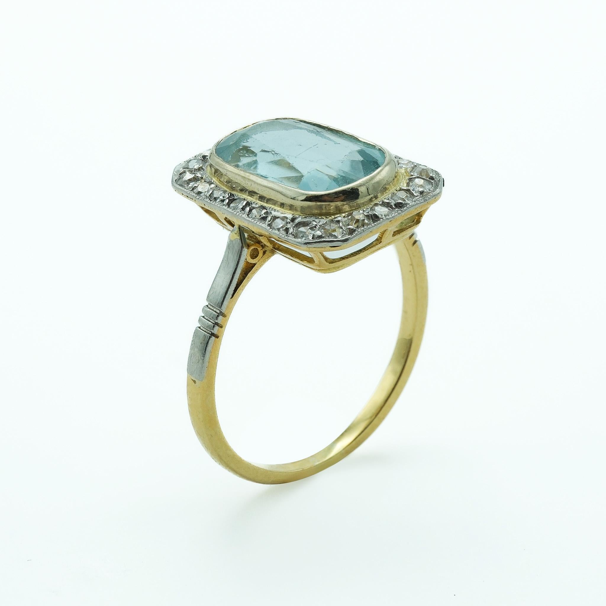 This ring is a fine example of Victorian-era craftsmanship, showcasing a blend of durability and elegance. The centerpiece, a cushion-cut aquamarine, is secured in a platinum setting, providing a durable and visually striking contrast. The stone's