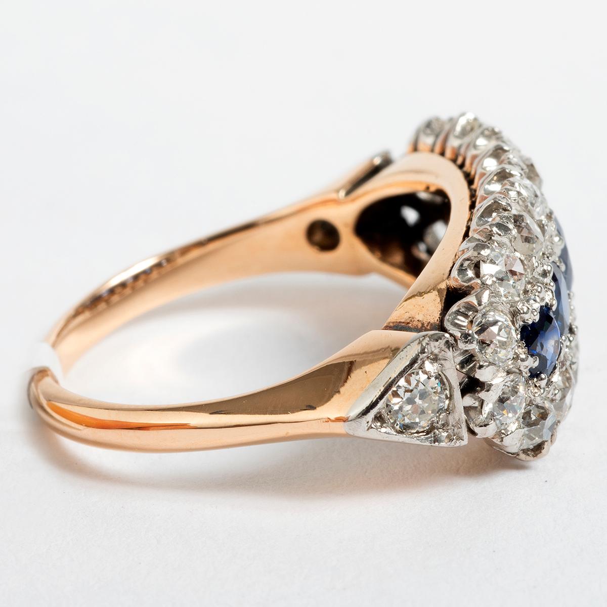 Set in 18K Yellow gold, this vibrant platinum diamond and sapphire cluster ring ring is dated circa 1890's. An elegant piece and an ideal gift for her .... This ring comes in UK size O / US size 7.25. 