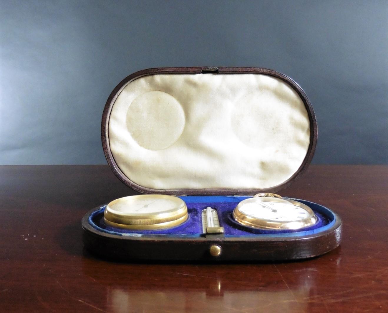 Victorian Pocket Watch, barometer and thermometer compendium set.

Housed in the original brown leather presentation case with hinged lid and blue velvet interior.

Inside the case rests a brass cased pocket watch surmounted by a crown winder