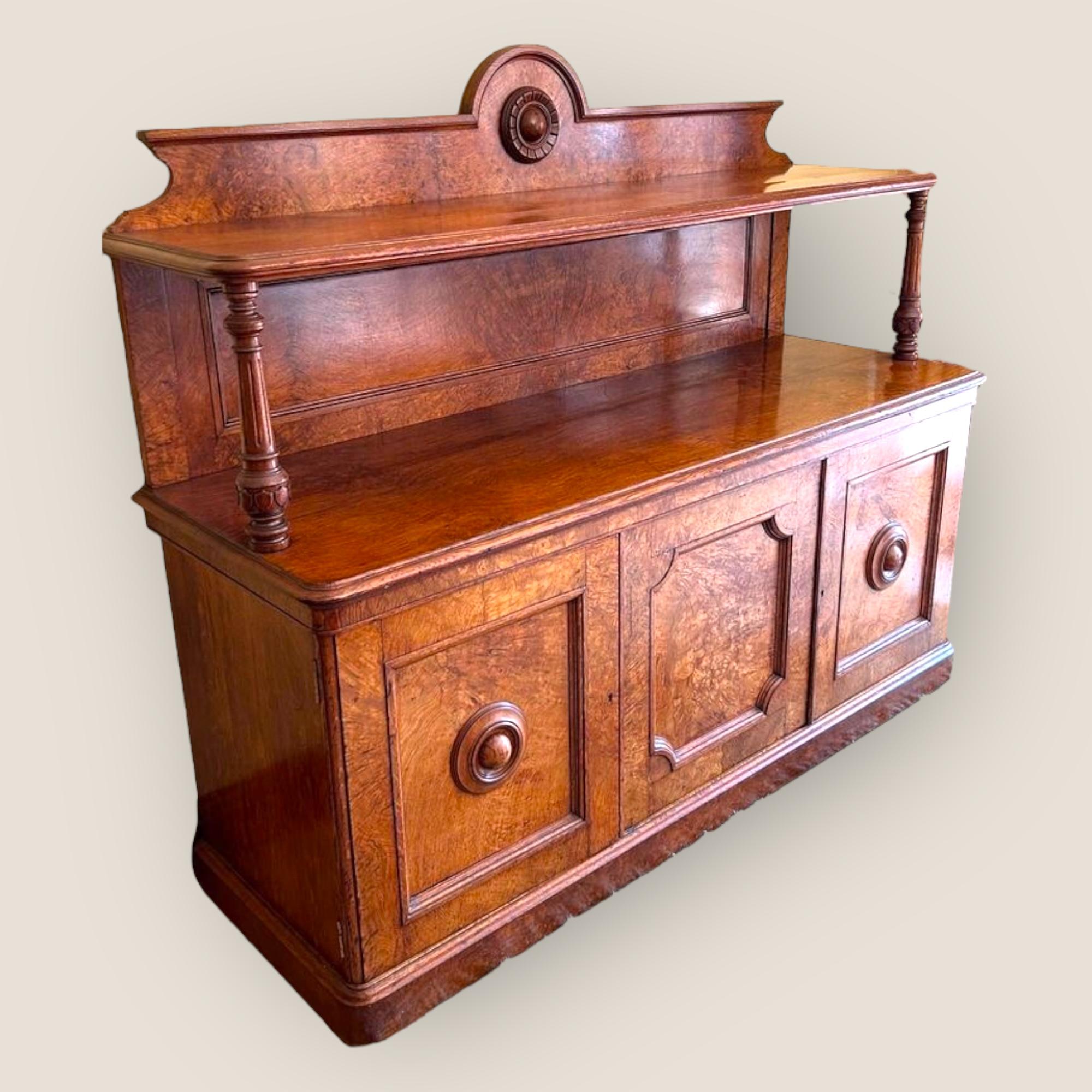 A Victorian Pollard Oak Sideboard With 3 Doors, and drawers in the interior. The Top shelf supported by two columns.