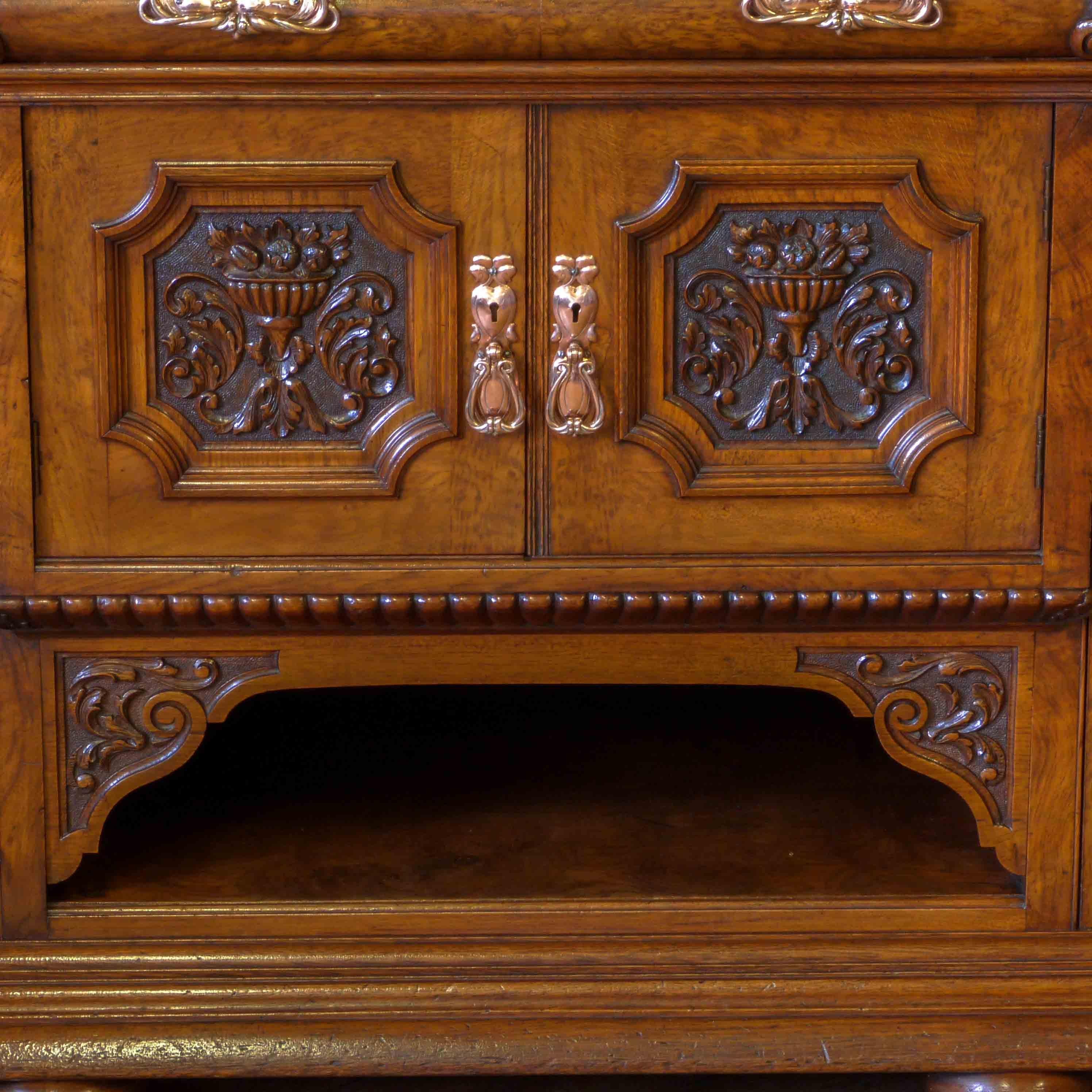 A fine Victorian pollard oak sideboard of outstanding quality and in superb condition. The mirrored top section has four turned and fluted columns that support a bow shaped crisply carved frieze, that terminates with an ogee cornice and a ribboned