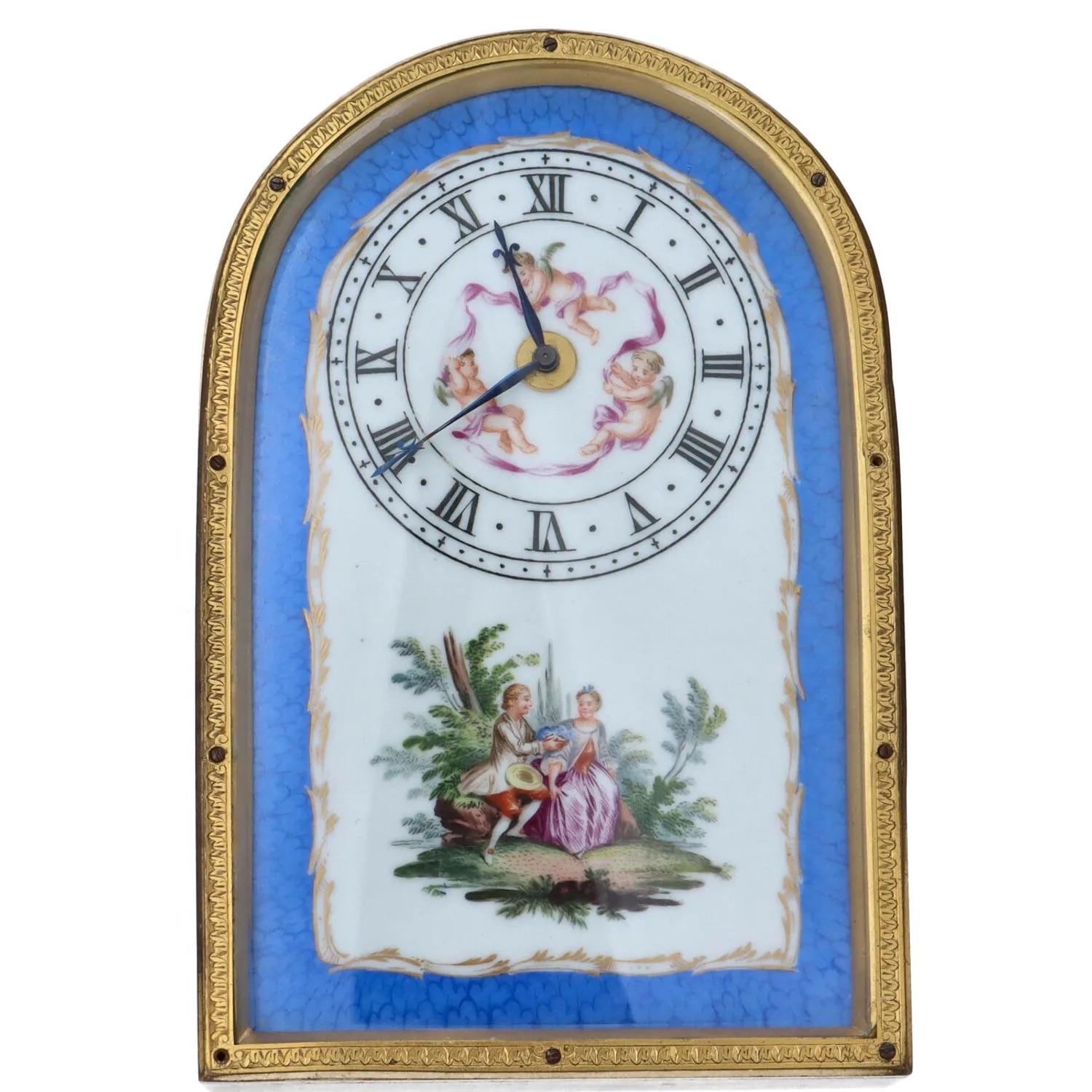 The strut clock of rectangular form with a domed top mounted in ormolu with beautifully engraved scrollwork to the sides and top. The clock fitted with a heavily engineered bracket to ensure it stands stable upon any surface. The glazed front
