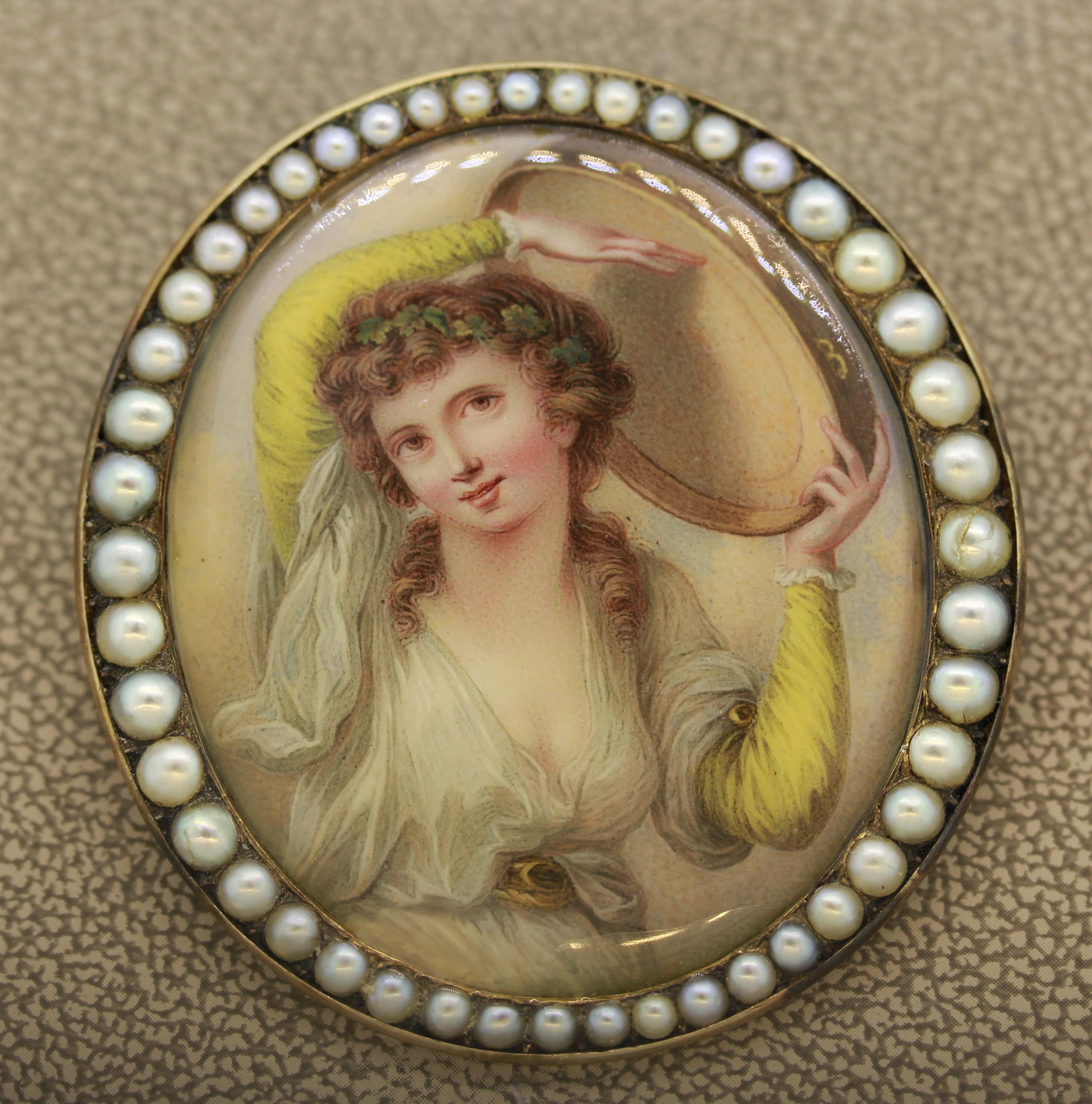An antique hand painted porcelain depicting a free woman playing a drum. The frame is set with natural seed-pearls in 14k yellow gold. The piece can be worn as a brooch or a pendant if a chain is attached to the bail. The pin-lock is missing a
