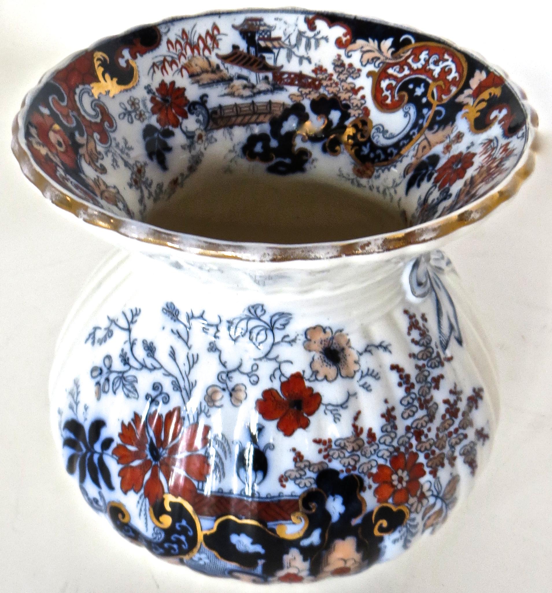 The mark on the underneath (see image) indicates that this spittoon is of Japanese Imari porcelain, manufactured circa 1880, and made specifically for the American market for the preponderance of bars and saloons at that time.
These were popular