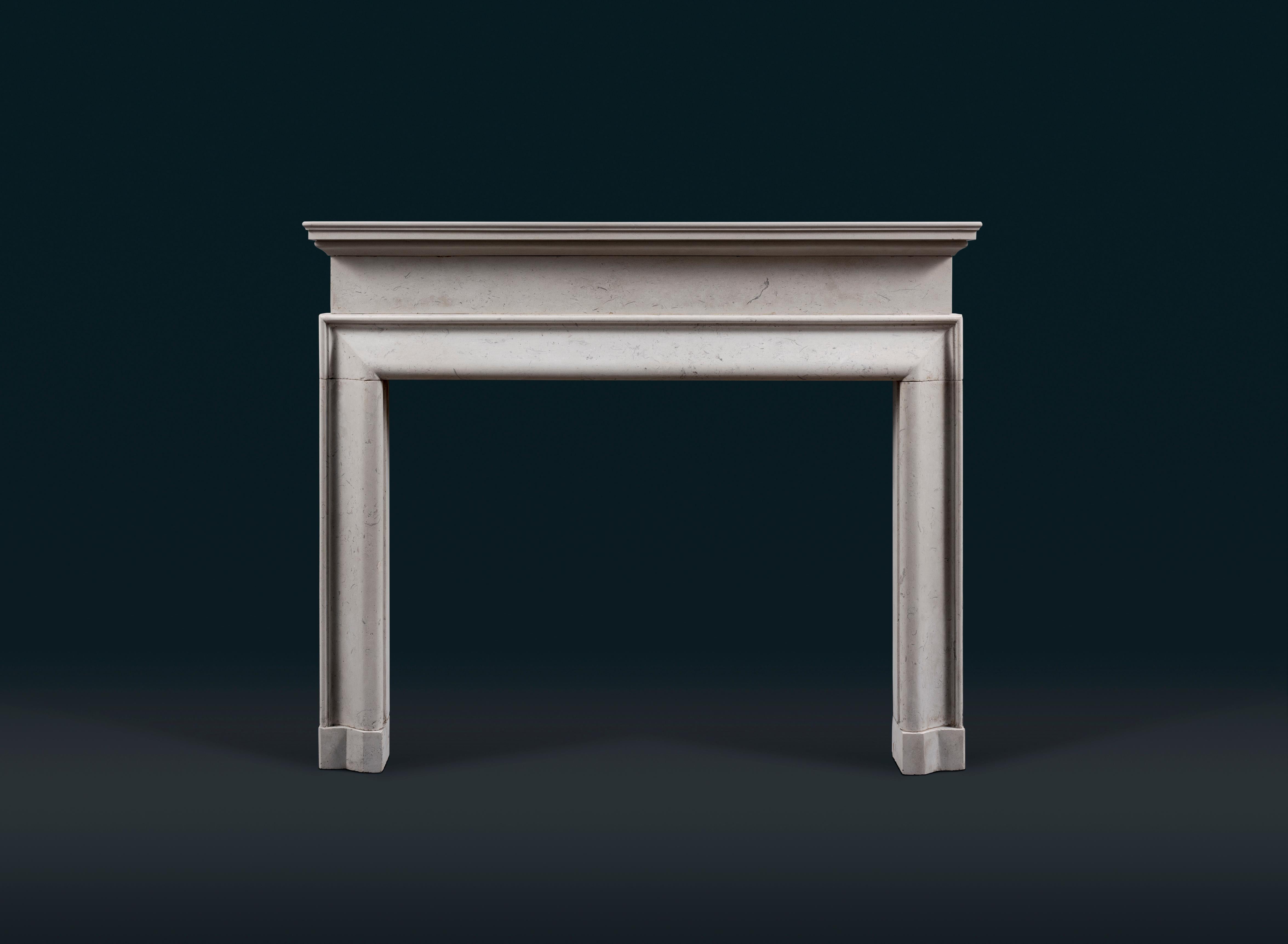 A Victorian architectural form Portland Stone bolection fireplace surround, with moulded shelf set above plain frieze, the opening surrounded by shallow ogee moulded frame, raised on shaped block feet. 

English, late nineteenth century.

The