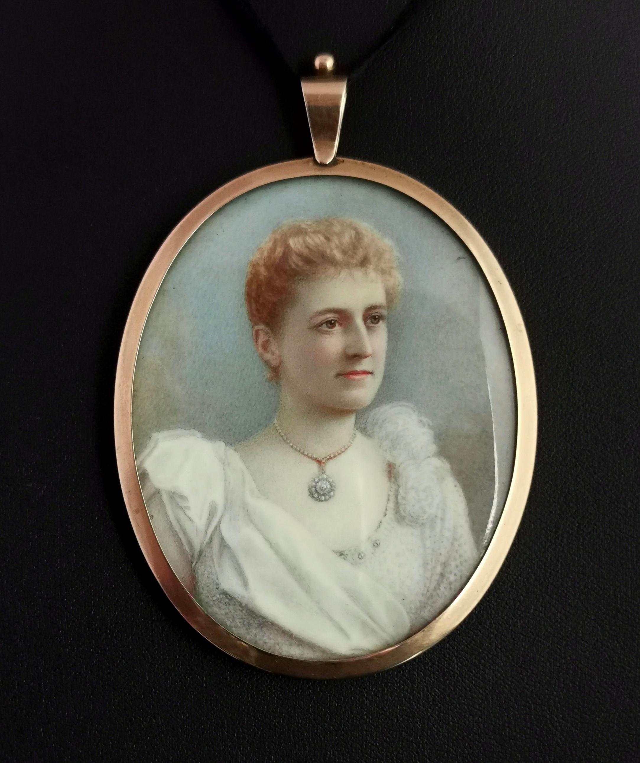 A very fine antique portrait miniature in gold with a pendant fitting.

It is a large piece with a rich 9 karat gold bezel frame with glazed covers either side, the front features the most beautiful hand painted portrait of a lady in a dress with a