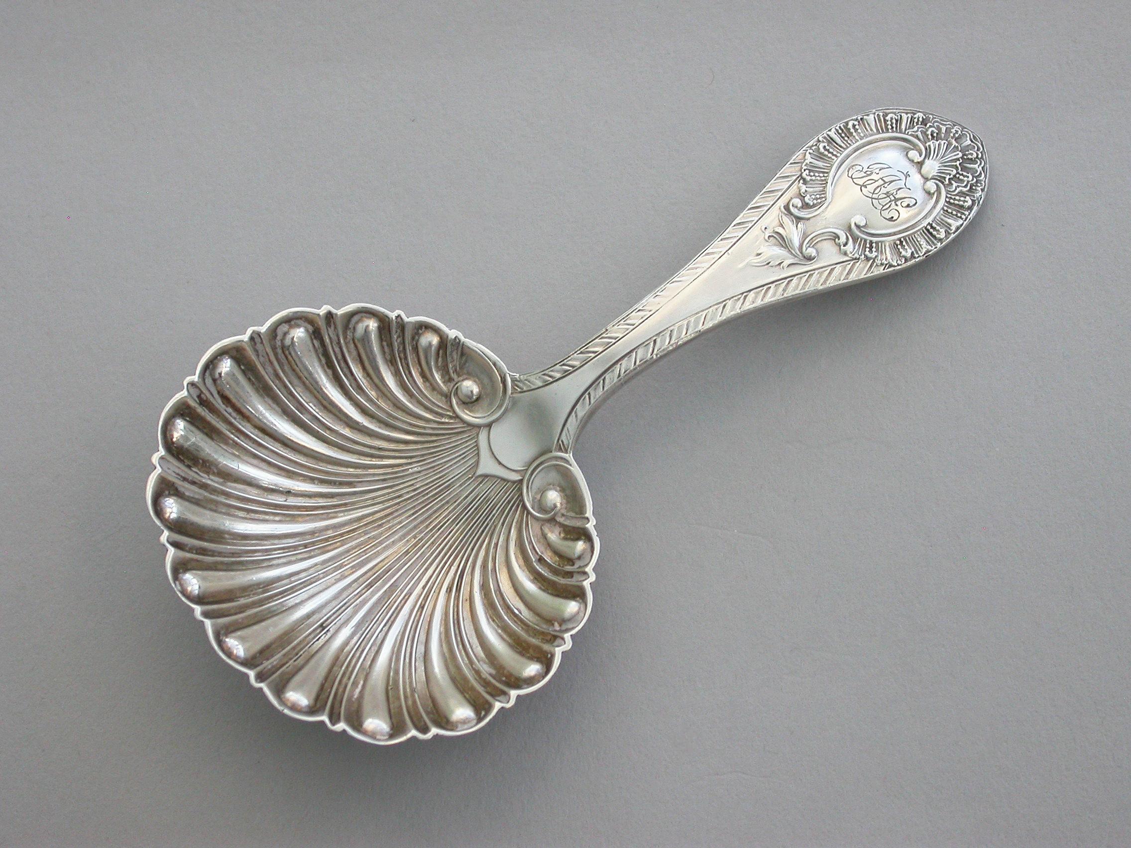 A good quality Victorian Provincial cast silver Caddy Spoon with fluted scallop shaped bowl and feather edge handle.

By Martin Hall & Co, Sheffield, 1866.

Also struck with diamond registration mark.

Weight 17.50 Grams (0.56 troy ounces)