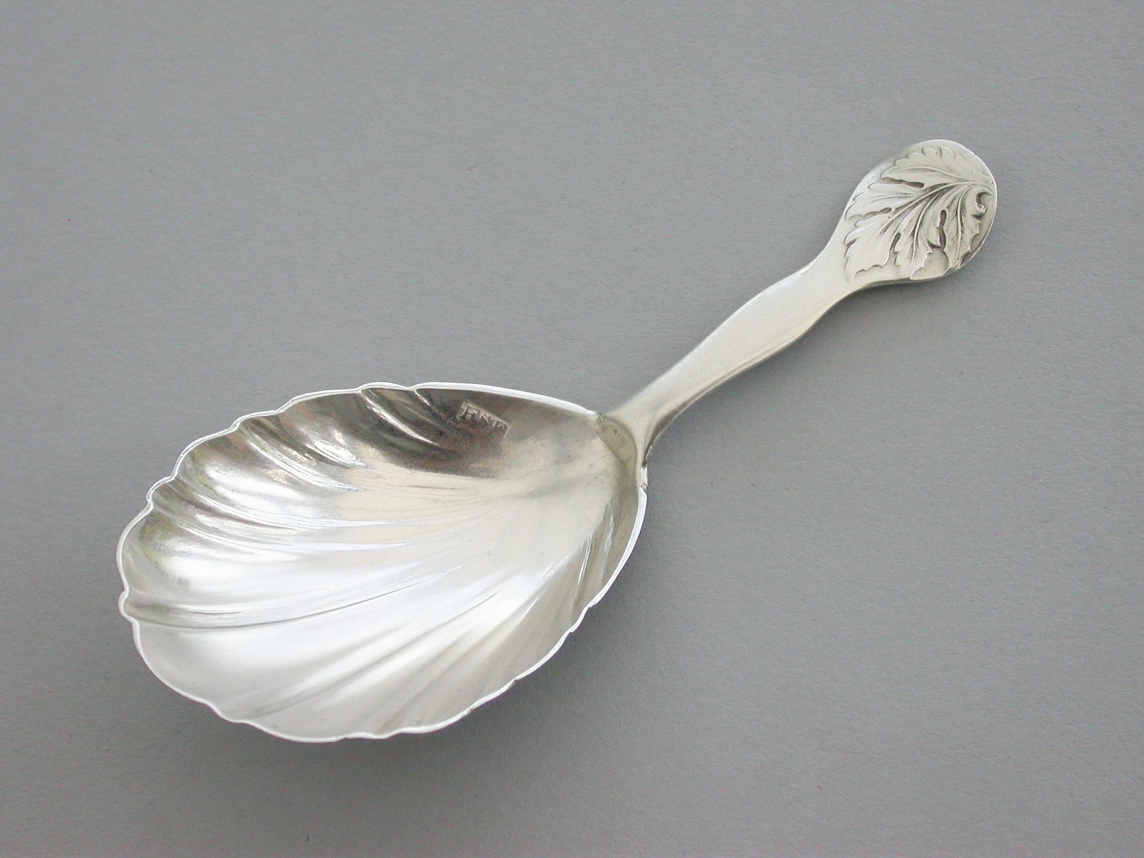 A good Victorian Provincial silver caddy spoon with elongated shell shaped bowl, the shaped handle with chased leaf terminal.

This West Country spoon has become known as the 