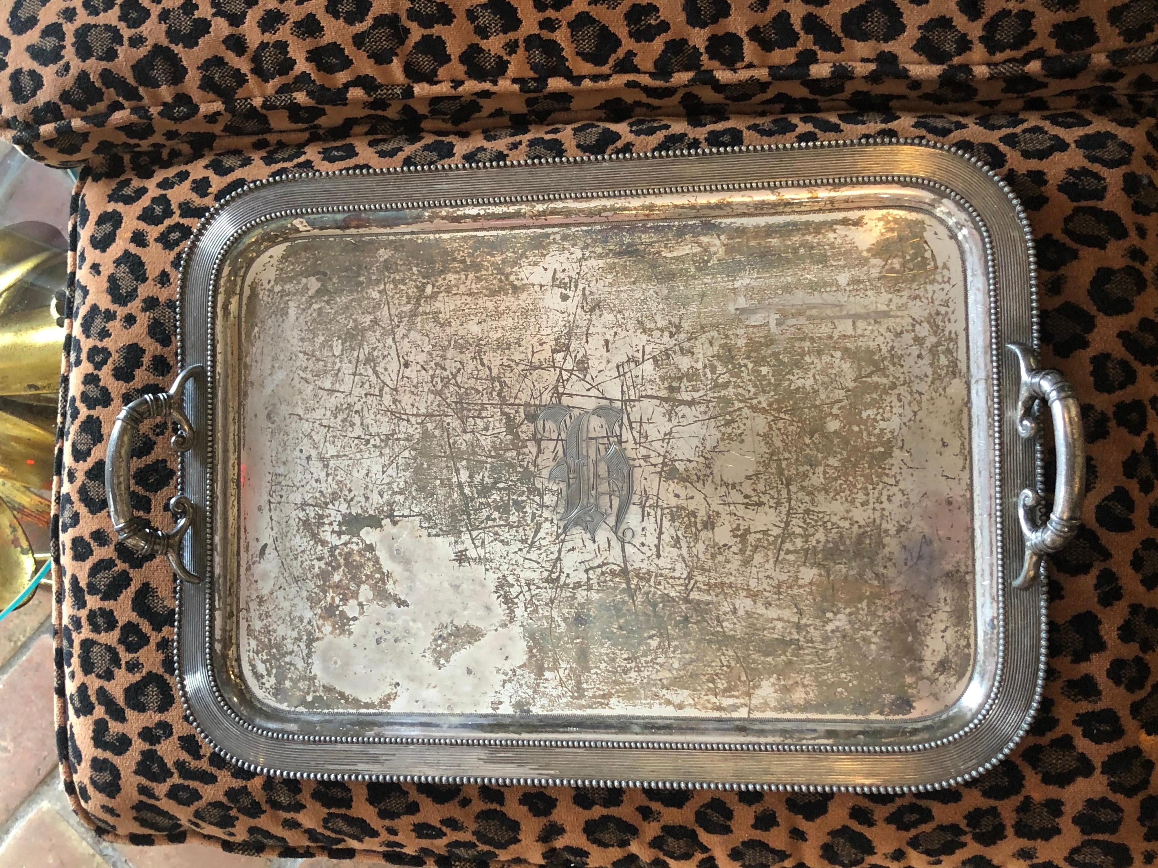Victorian monogrammed Quadruple plated Silver serving tray. This item has been heavily used. It has a script monogram of two letters on the the center area. It looks like possibly an 