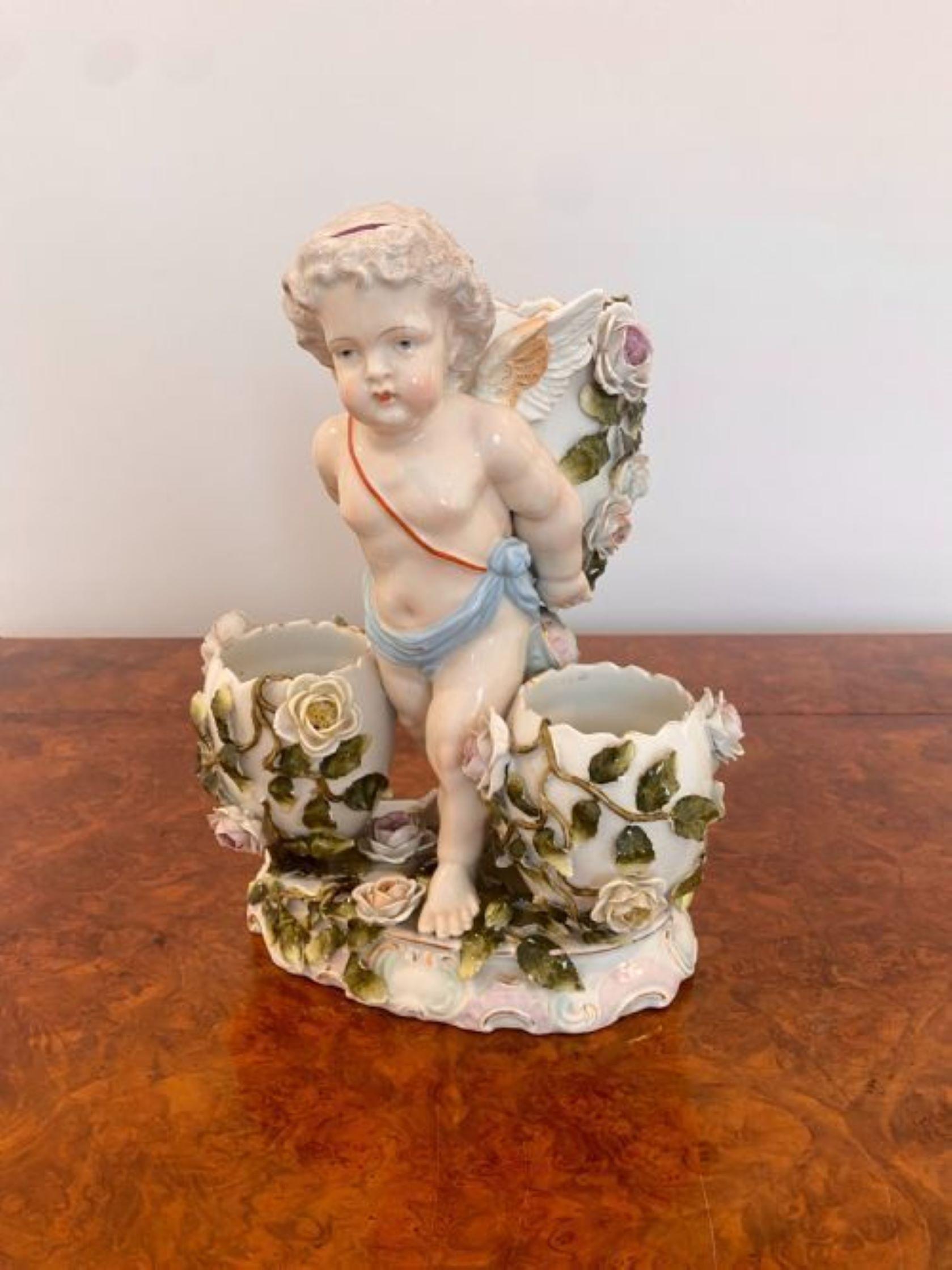 Antique Victorian quality continental porcelain cherub. Quality continental porcelain cherub with three shaped vases decorated with flowers and leaves in wonderful hand painted red, blue, green and pink colours raised on a ornate base