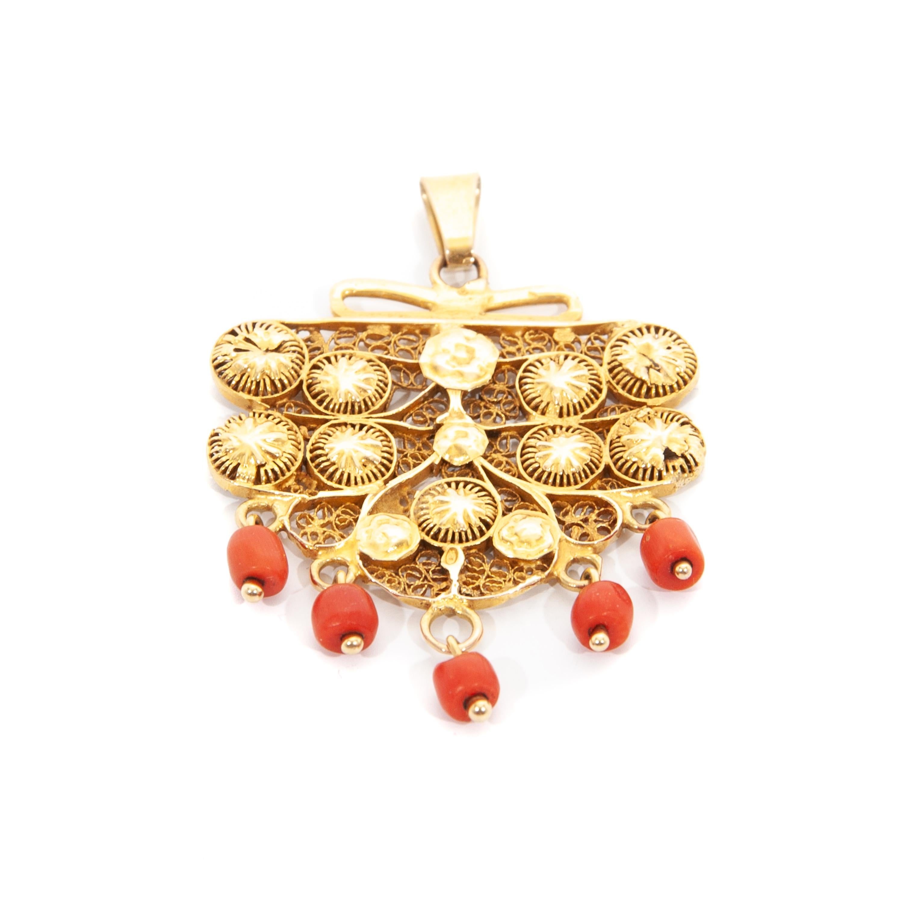 This is an antique 14 karat yellow gold pendant created with five natural red coral bead stones. The gold is made of fine filigree and cannetille work. The cannetille work on this pendant is beautiful, it typically features fine gold wires or thinly