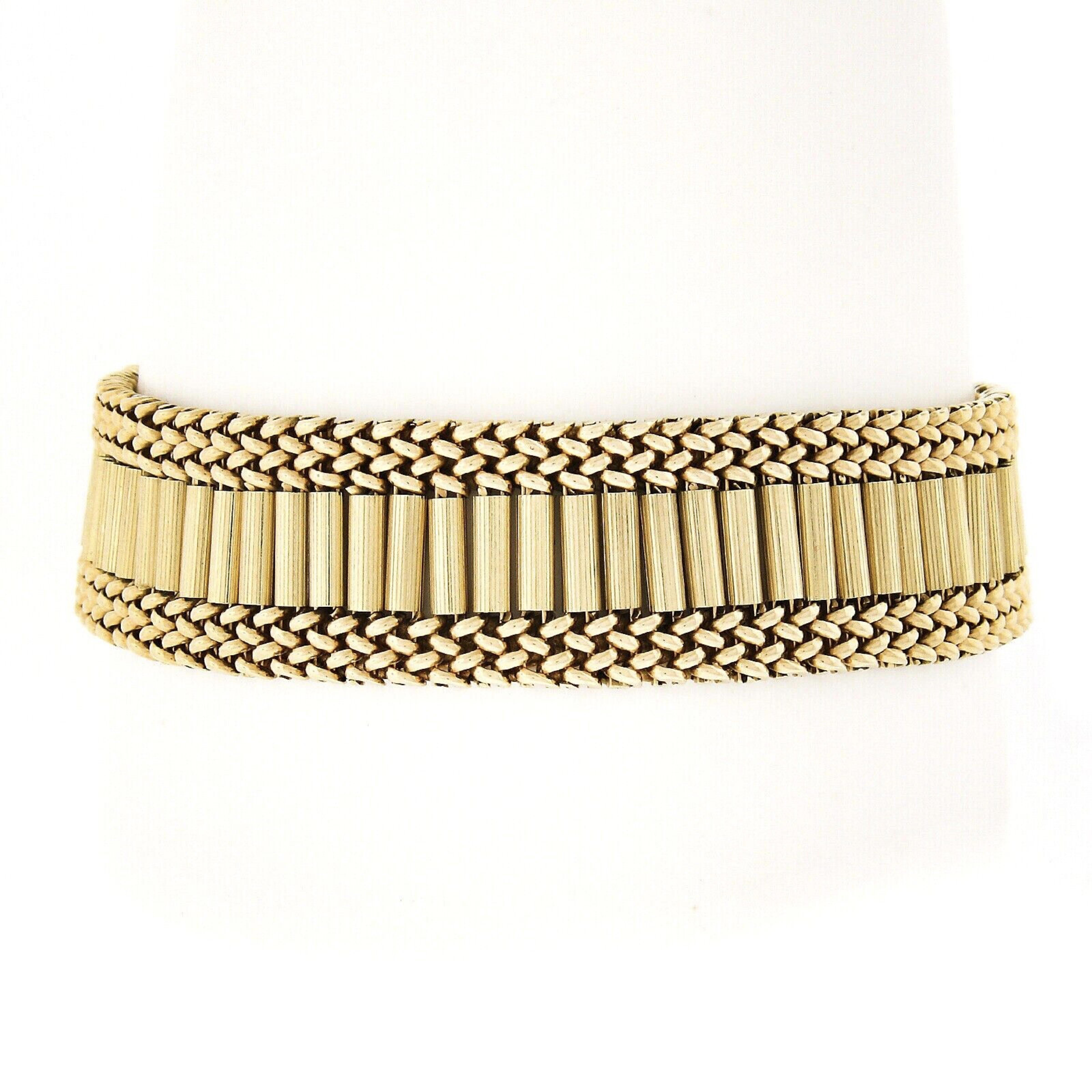 You are looking at a gorgeous and very well made vintage strap bracelet that was crafted in solid 14k yellow gold featuring a magnificent Victorian revival design. The wide strap is constructed from neatly set polished braided links and textured bar