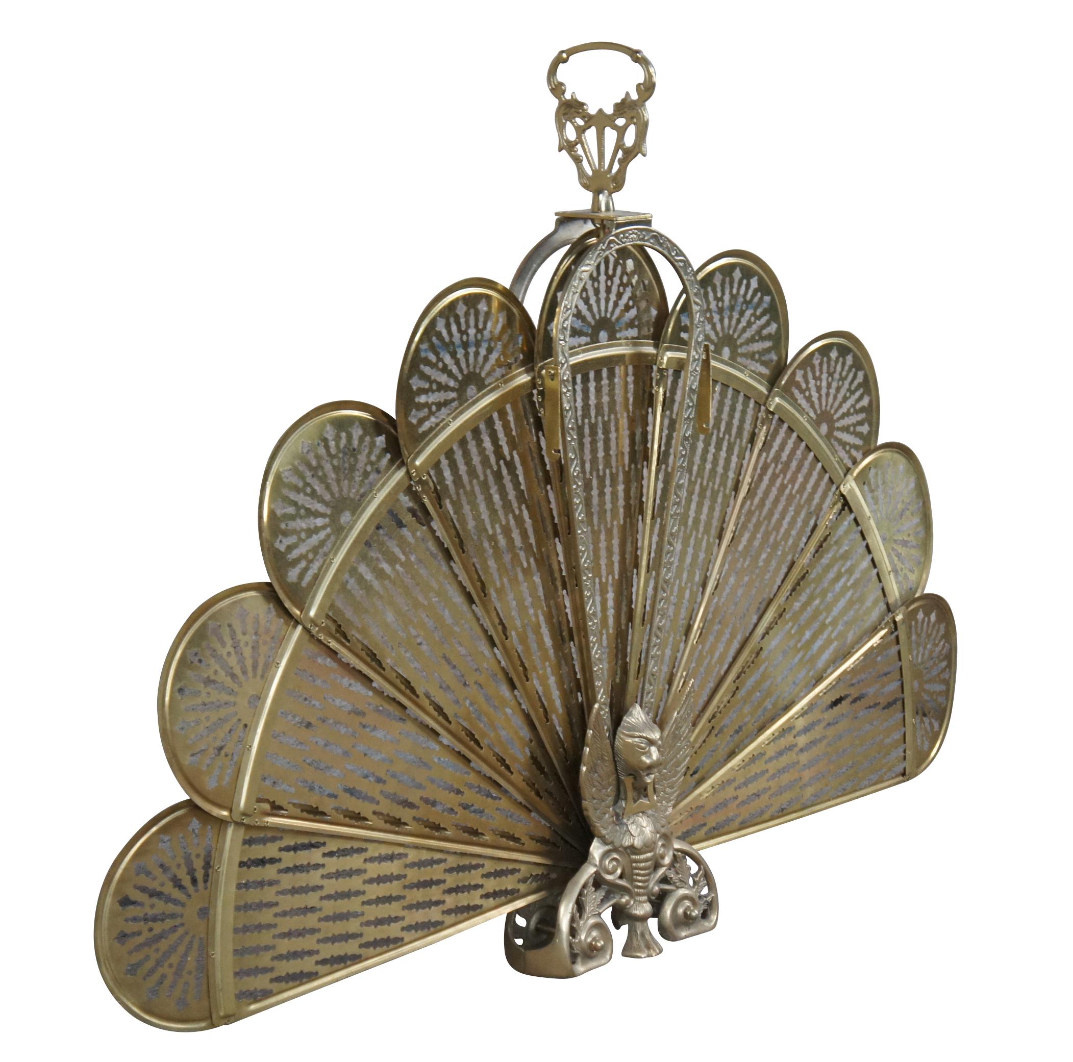 A vintage brass fireplace fan inspired by Art Deco & Victorian styling.  Features a peacock design with pierced blades, ornate handle and scrolled figural Phoenix / Griffin foot.  An eye catcher for any space!

Dimensions: 
Closed - 7