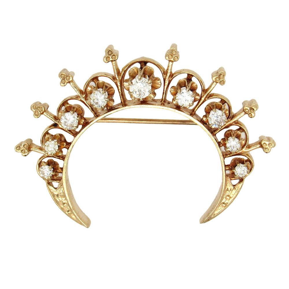 Victorian Revival diamond crescent pin, circa 1940's, is set with 9 diamonds, approx. 1 carat tw, in 14K gold.. The brooch measures 2