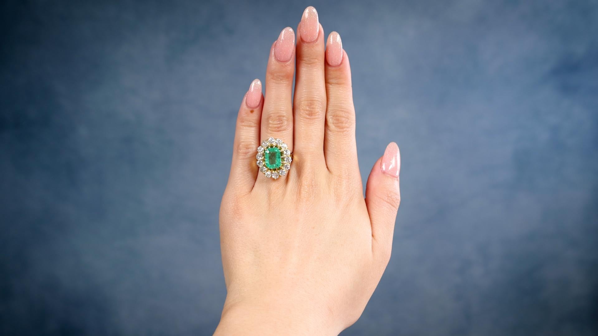 One Victorian Revival GIA 2.50 Carat Colombian Emerald Diamond 18k Yellow Gold Cluster Ring. Featuring one octagonal step cut emerald weighing approximately 2.50 carats, accompanied by GIA #6237177988 stating the emerald is of Colombian origin.