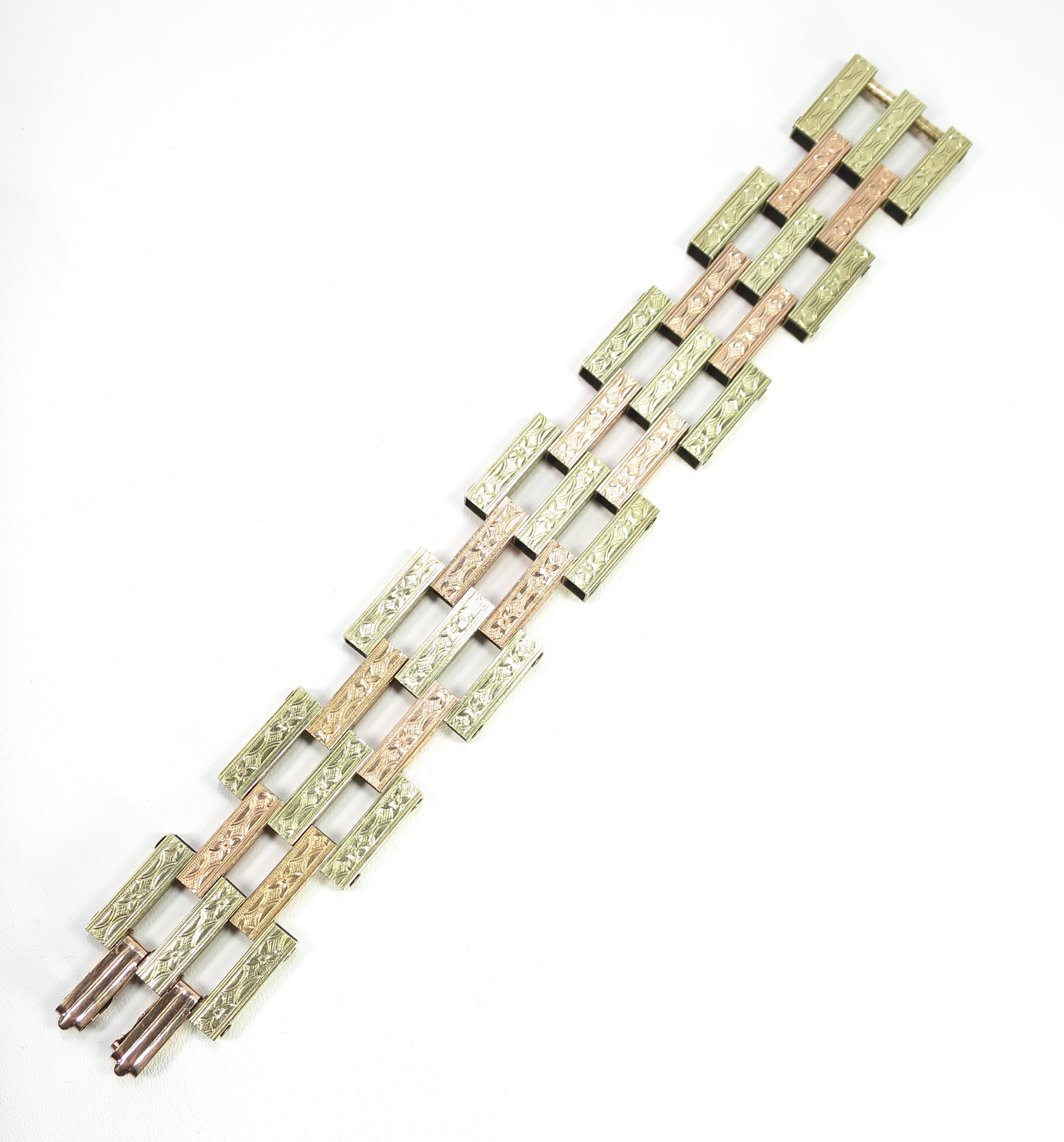 Offered here is a Victorian Revival etched link bracelet of rose and yellow rolled gold from the 1920s. The geometric design consists of rectangular hollowware panels that are riveted together in an overlapping construction, alternating between