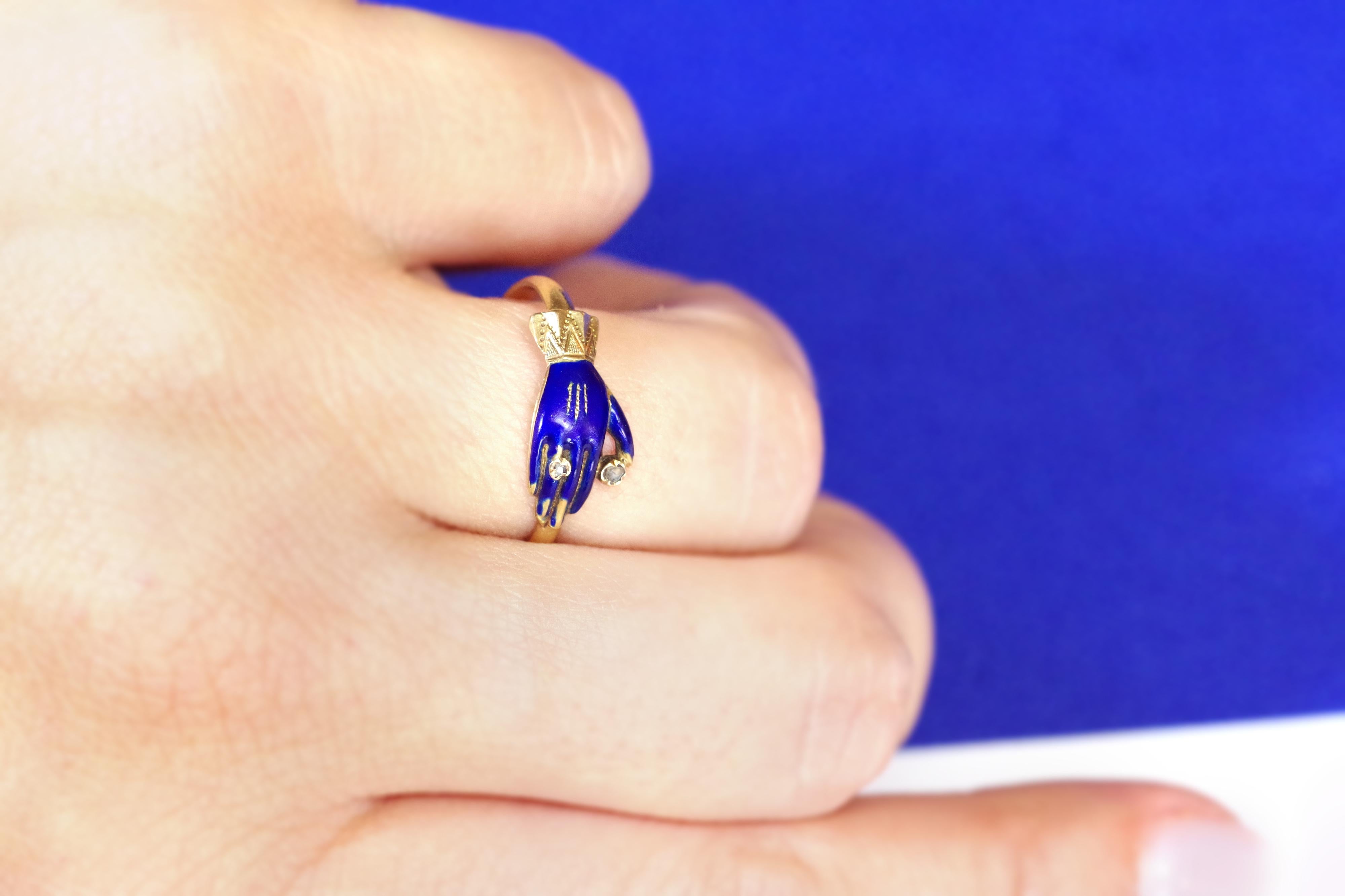 Victorian ring hand enamel diamond in yellow gold 18 karats. Antique promise ring representing a gloved hand wearing a ring and holding a rose-cut diamond. The glove is enamelled dark blue color, the sleeve is in gold chiselled with patterns. The