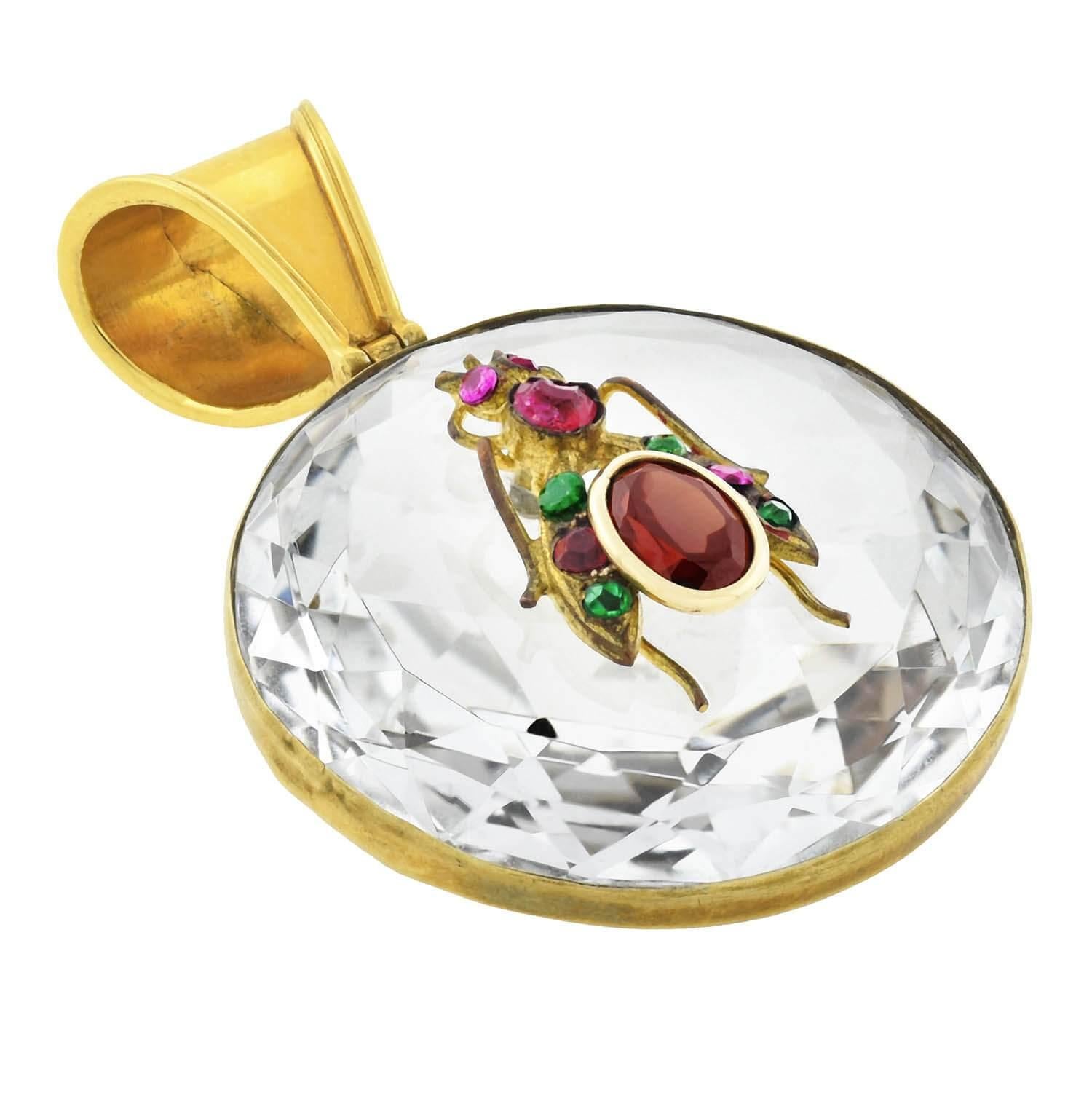 A simply outstanding rock crystal and gemstone insect pendant from the Victorian (ca1880s) era! This fabulous piece is crafted out of a relatively large rock crystal plaque, which is held within a vibrant 14kt yellow gold frame. The entire back of