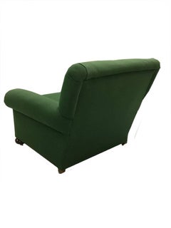 An English 19th Century green deep seated club roll arm chair