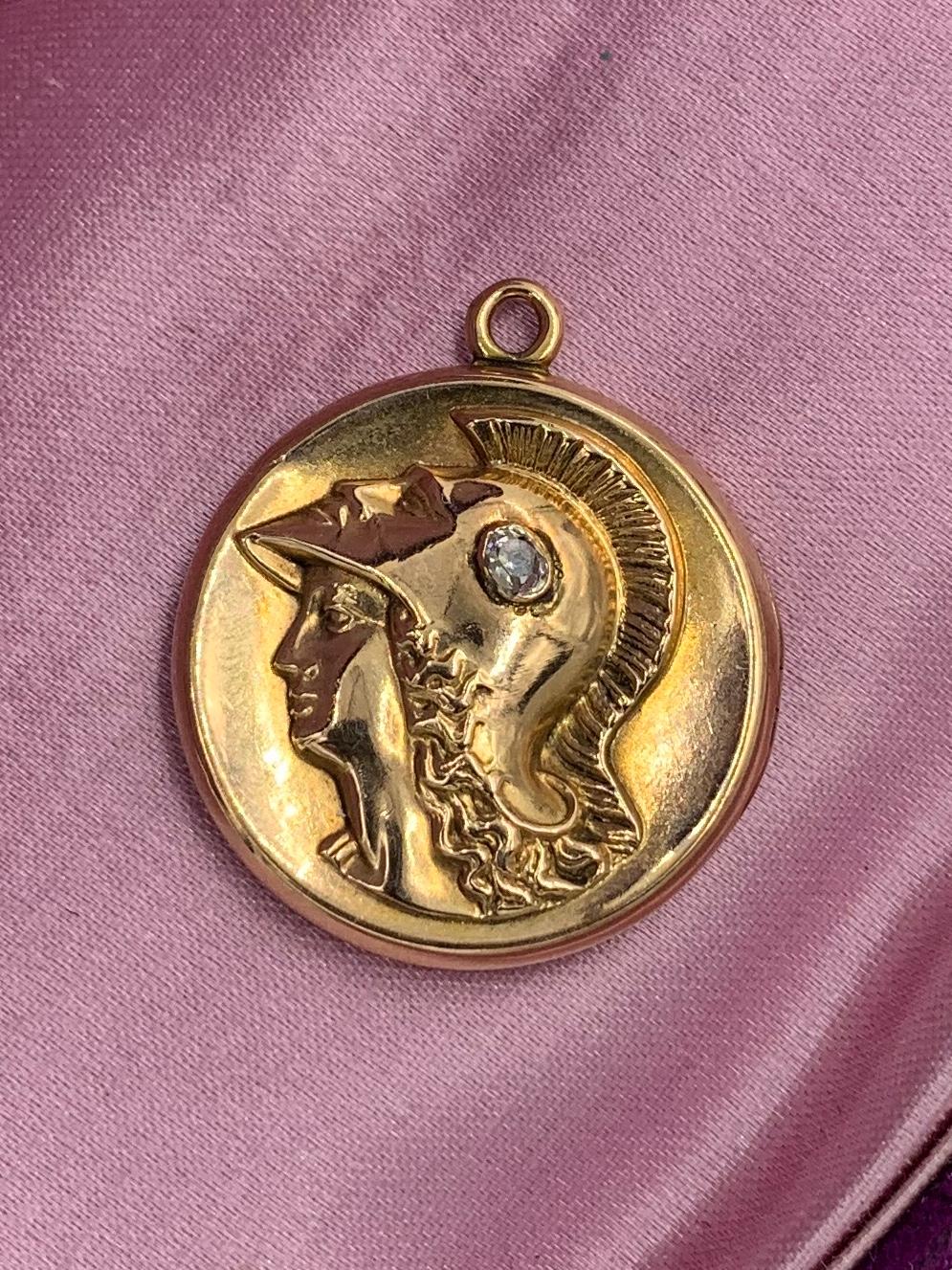 This is a gorgeous Victorian - Belle Epoque Picture locket pendant with a stunning Roman Neoclassical Warrior set with a .15 Carat Old Mine Cut Diamond.  The locket is the most stunning 14 Karat Gold.  The wonderful image of the Warrior is